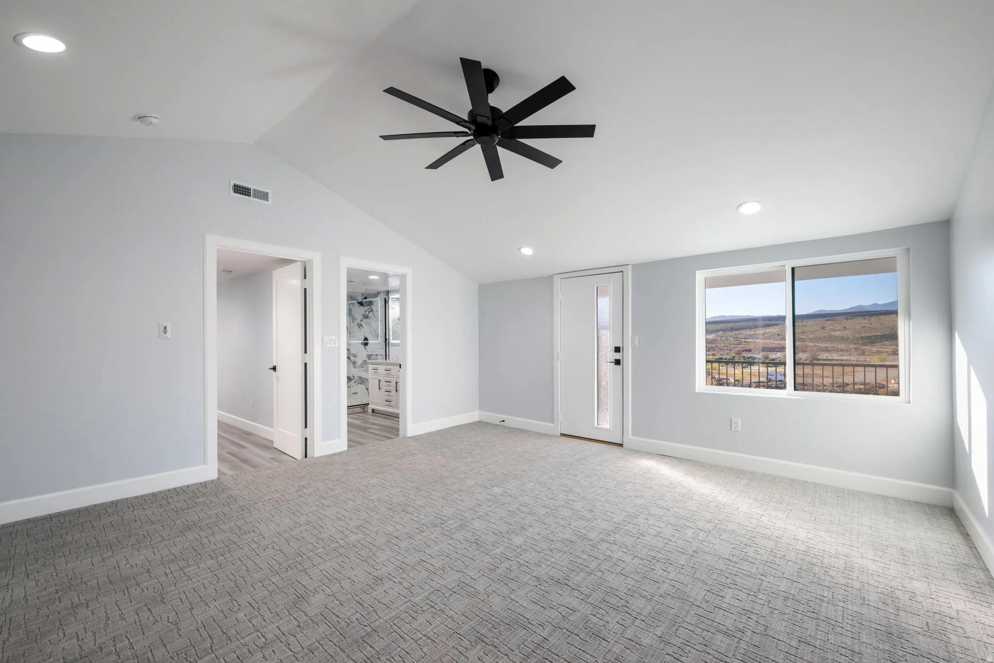 Unfurnished living room featuring light colored carpet, ceiling fan, and recessed lighting