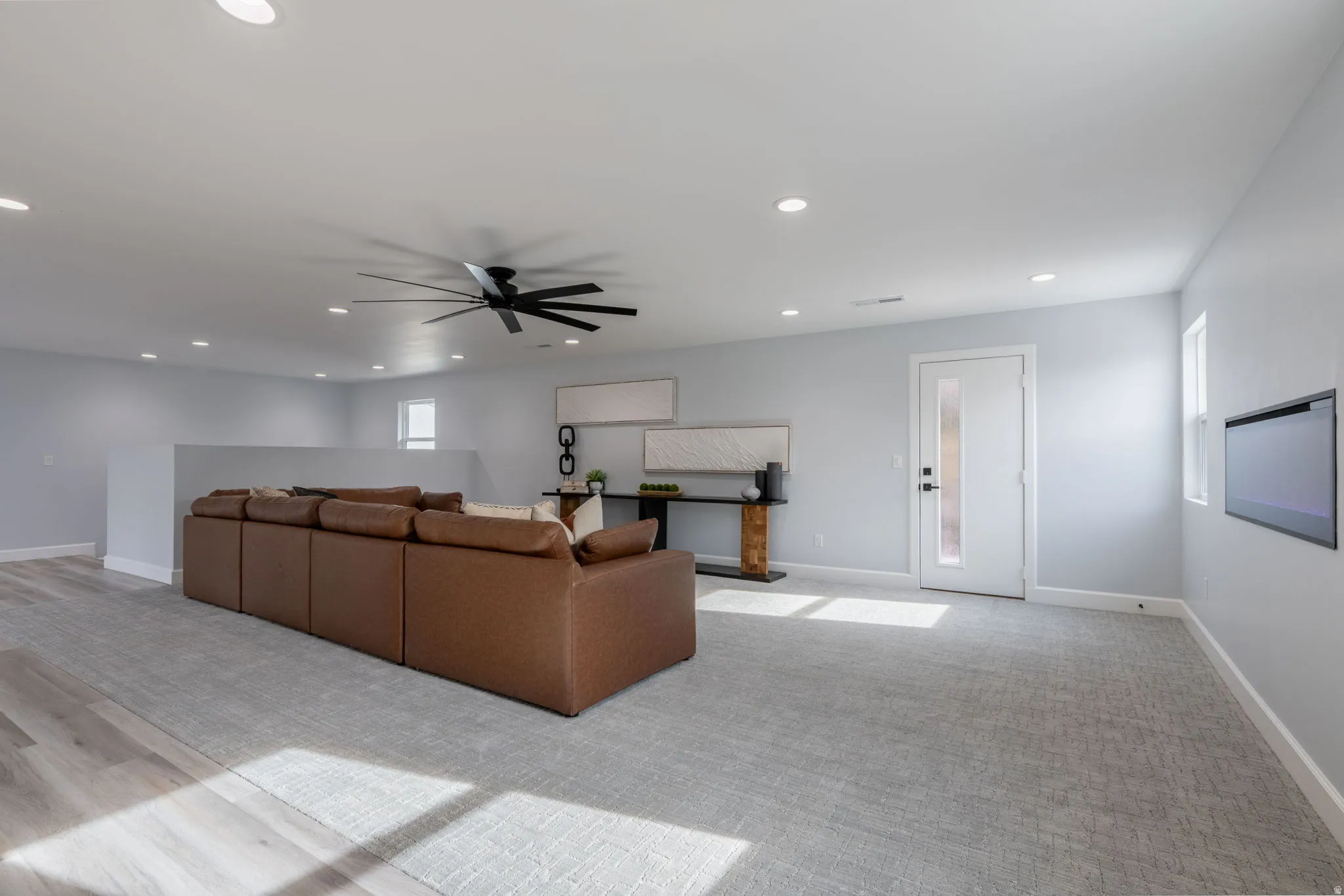 Living room featuring ceiling fan, recessed lighting, and light carpet