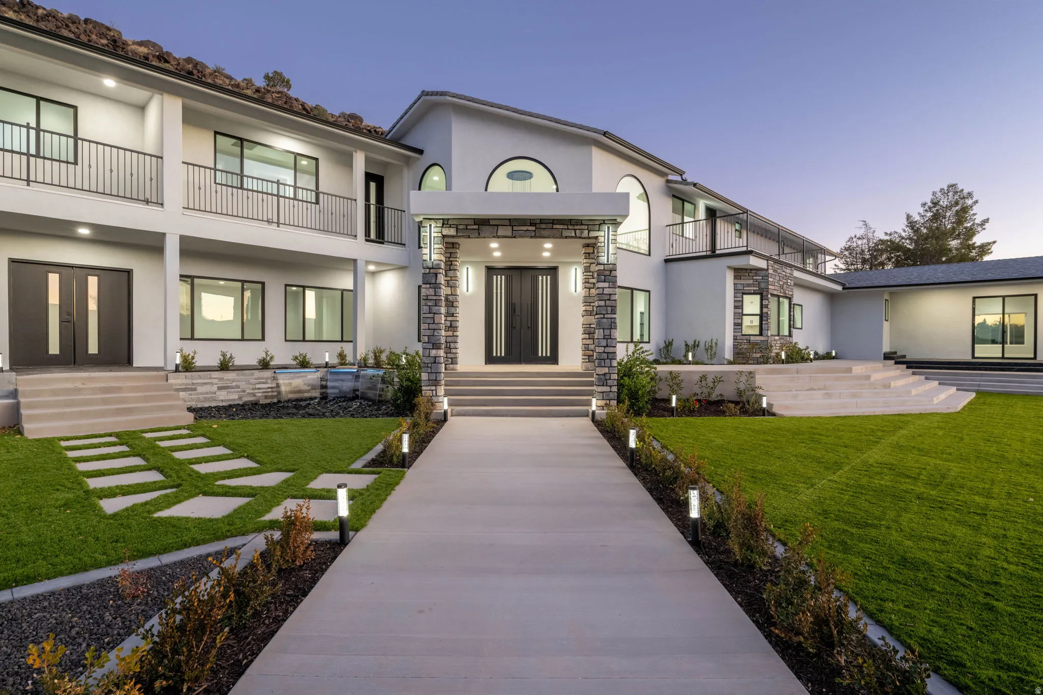Back of house featuring french doors, stucco siding, and a balcony