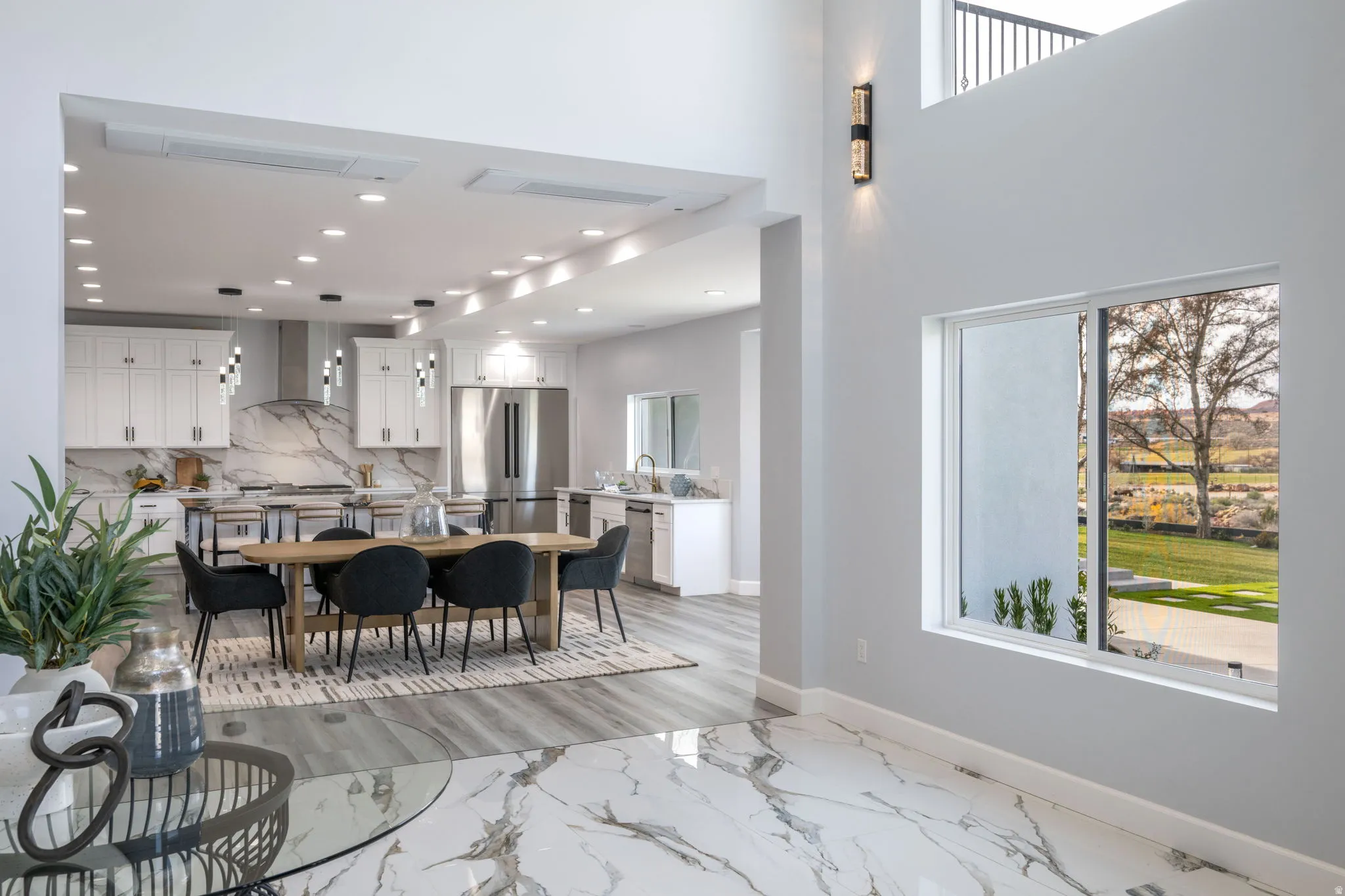Dining area with a high ceiling and recessed lighting