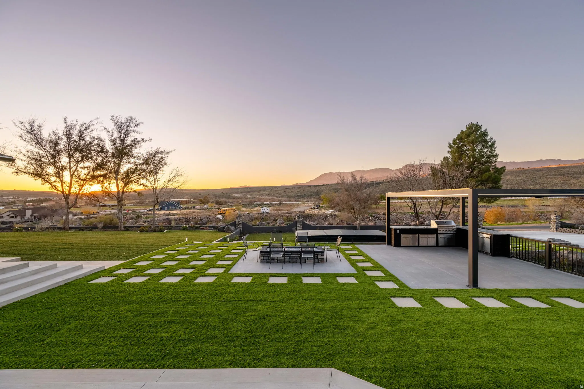View of grassy yard featuring a patio and a mountain view