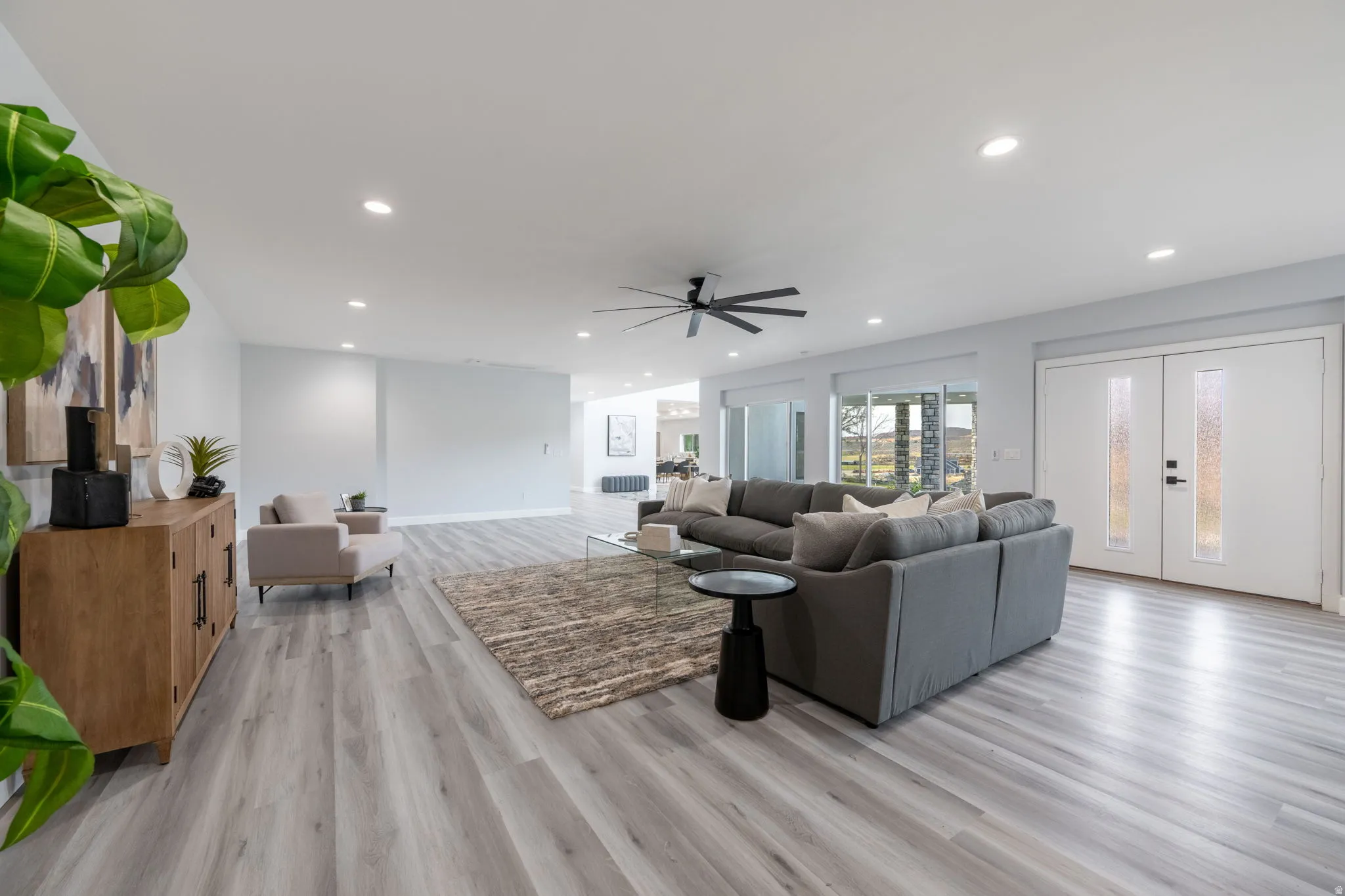 Living room with light wood-type flooring, french doors, recessed lighting, and ceiling fan