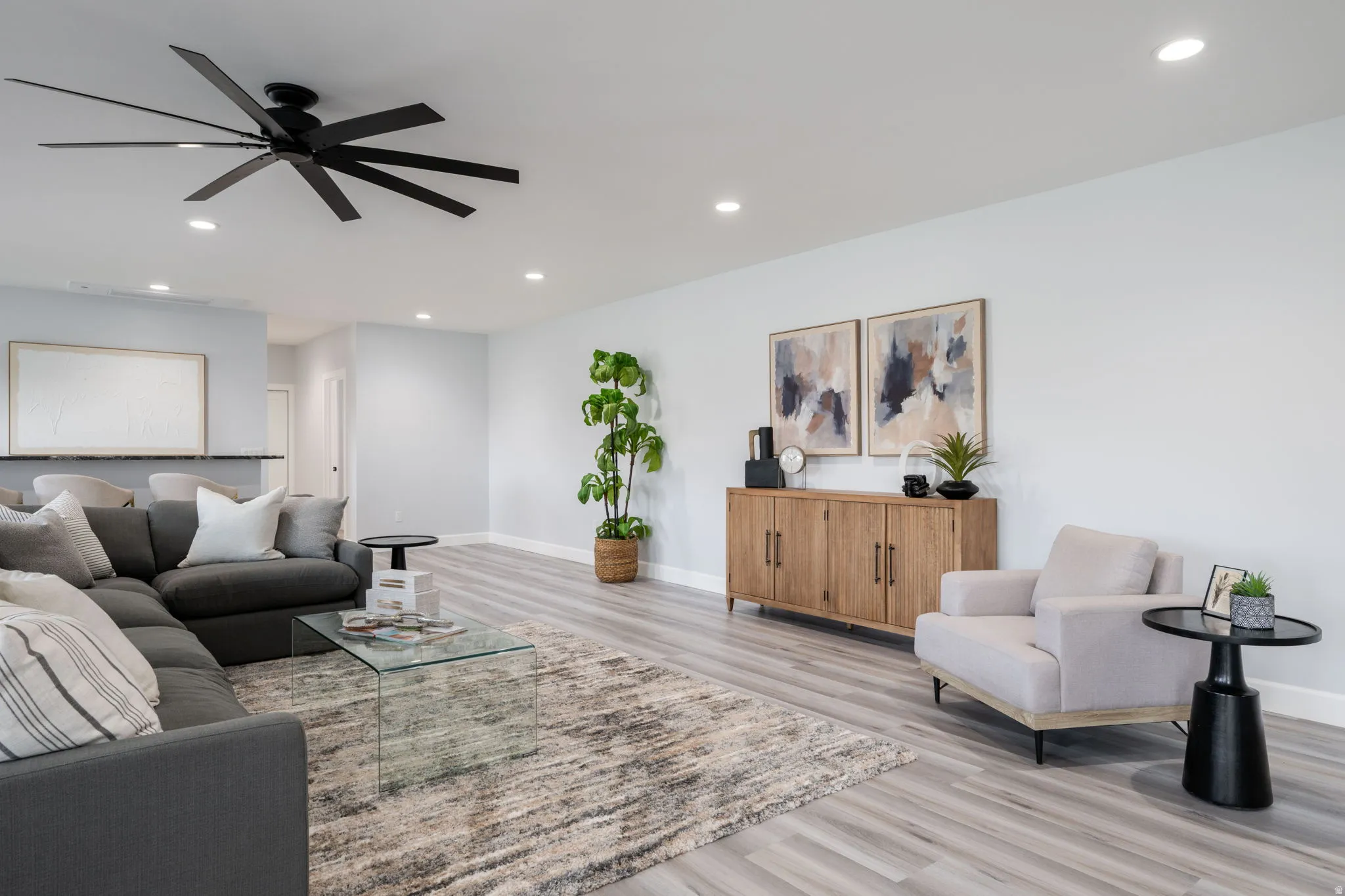 Living room with recessed lighting, light wood-style floors, and ceiling fan