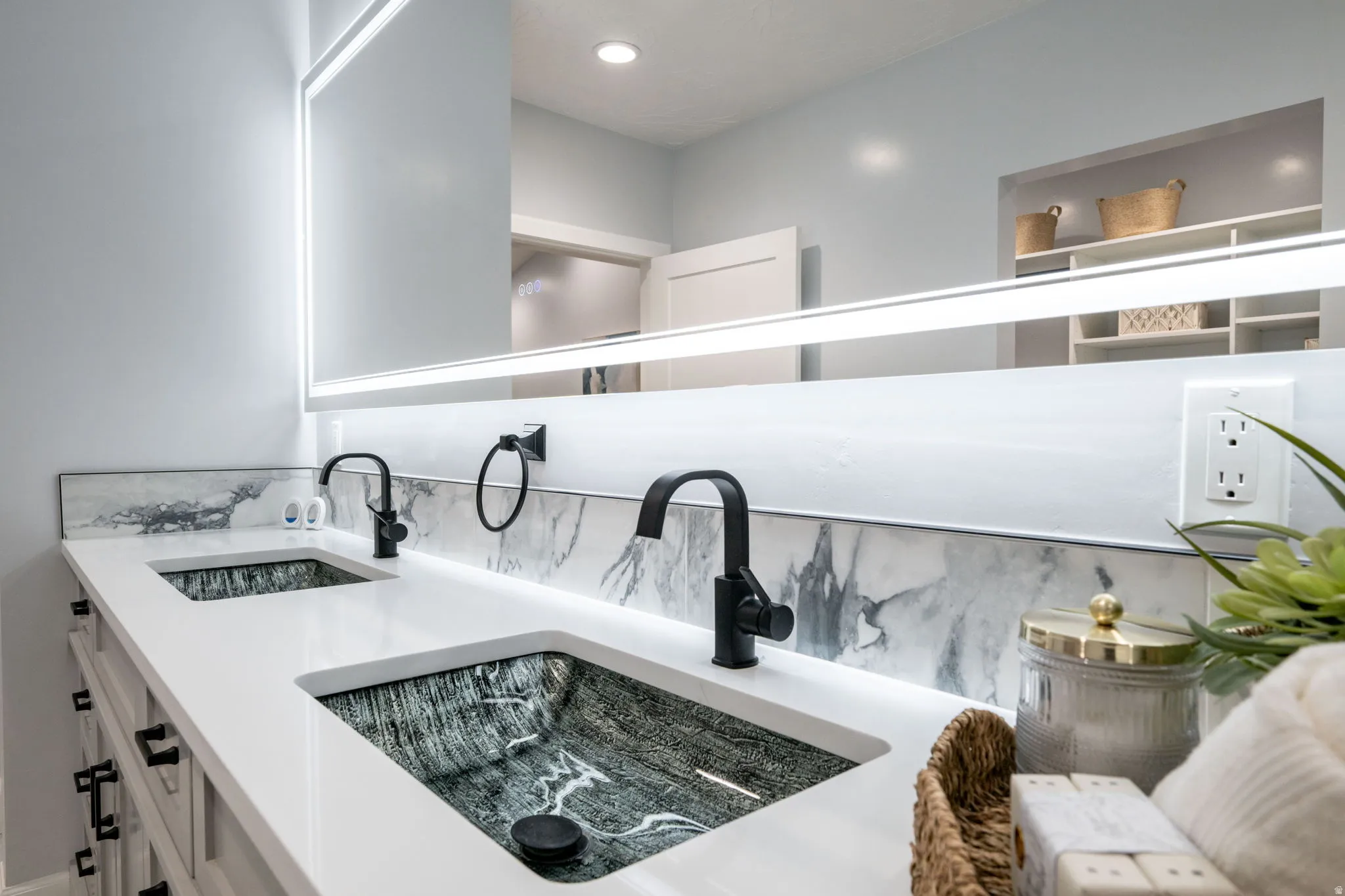 Bathroom view of double vanity and an outdoor fire pit