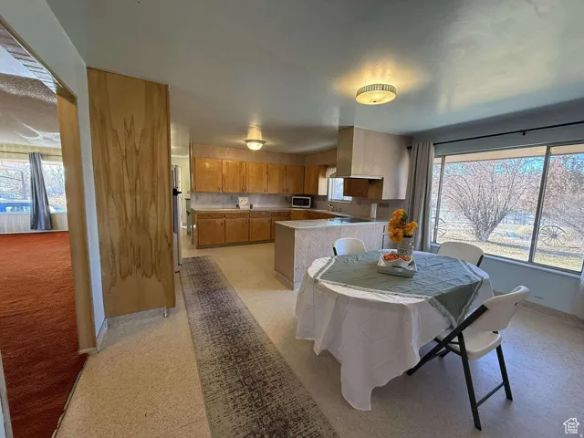 Dining area featuring light floors and plenty of natural light