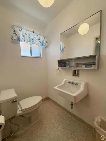 Half bathroom with toilet and a sink