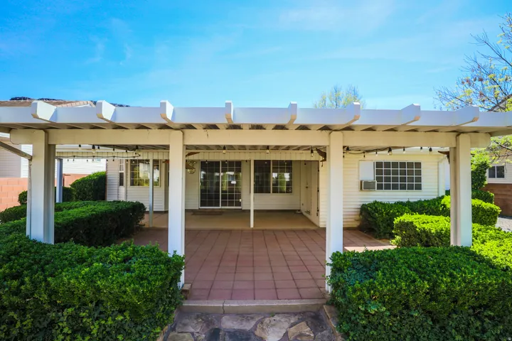 Back of house with a patio and a pergola