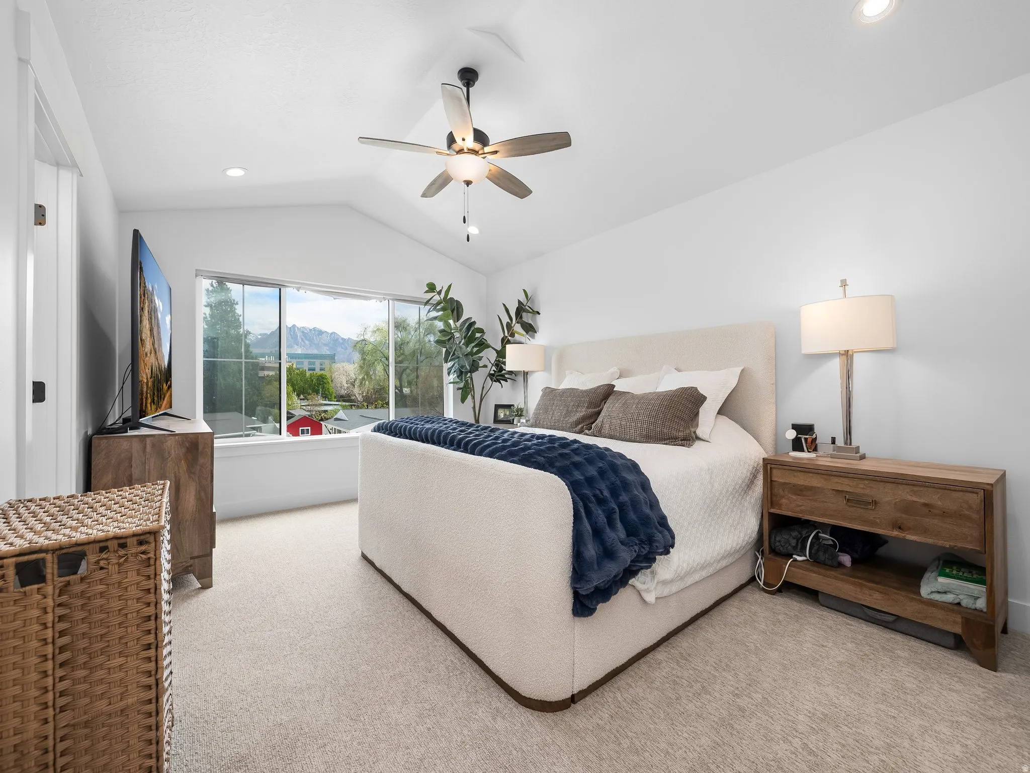 Bedroom with light colored carpet, ceiling fan, vaulted ceiling, and recessed lighting