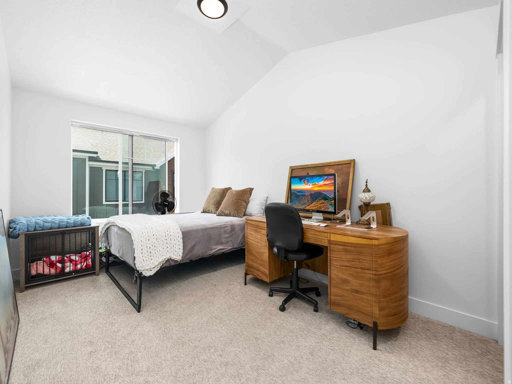 Bedroom with light carpet, lofted ceiling, a desk, and access to exterior