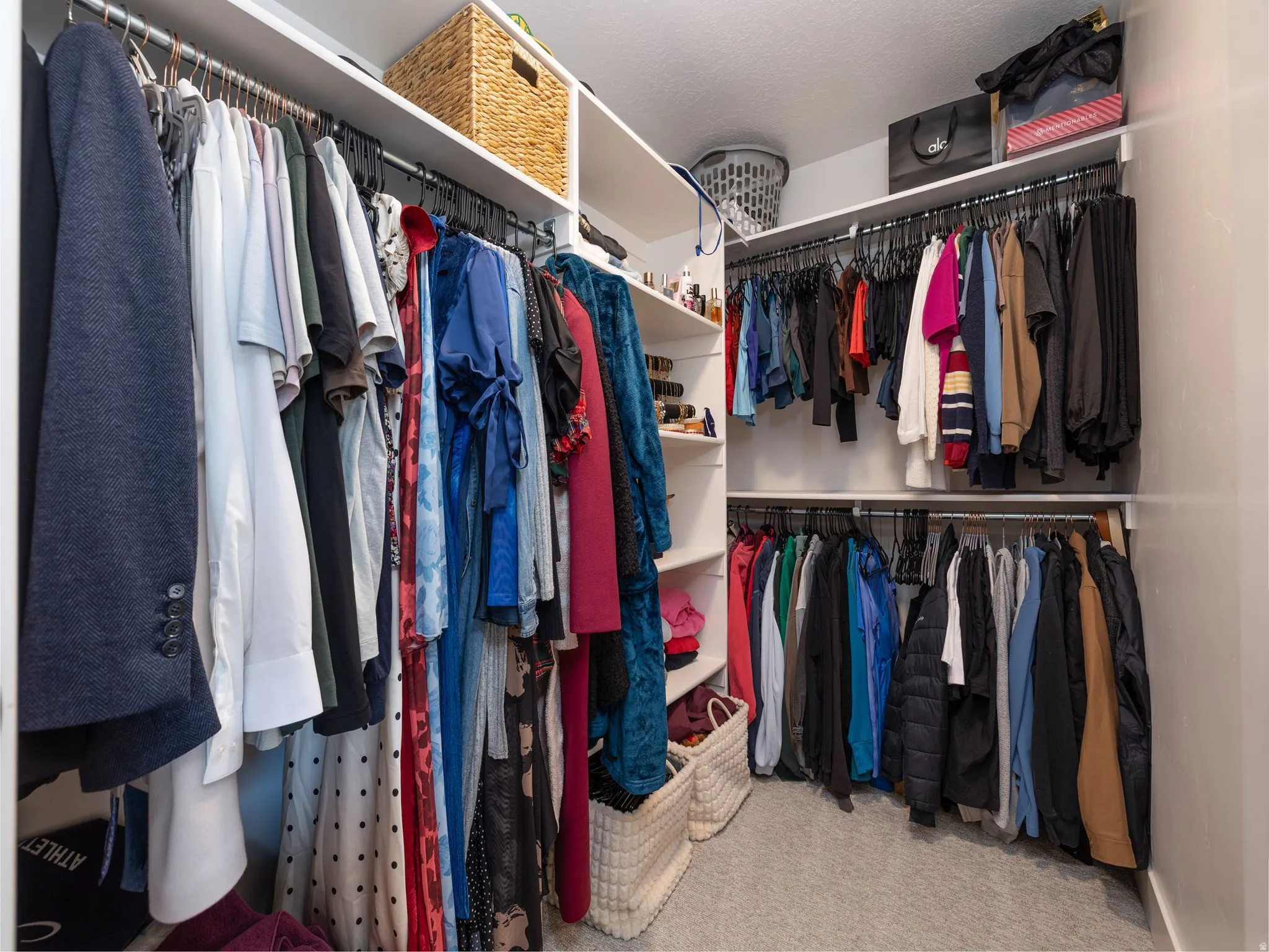Walk in closet with light colored carpet