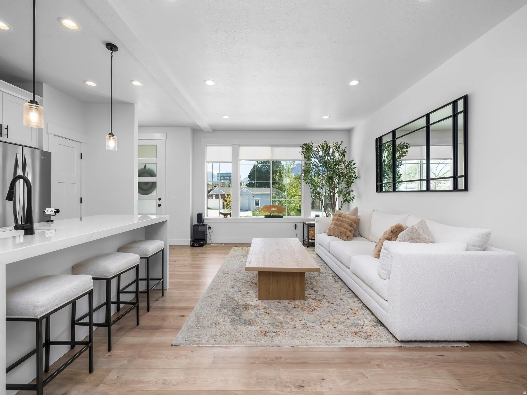 Living room featuring light wood finished floors and recessed lighting