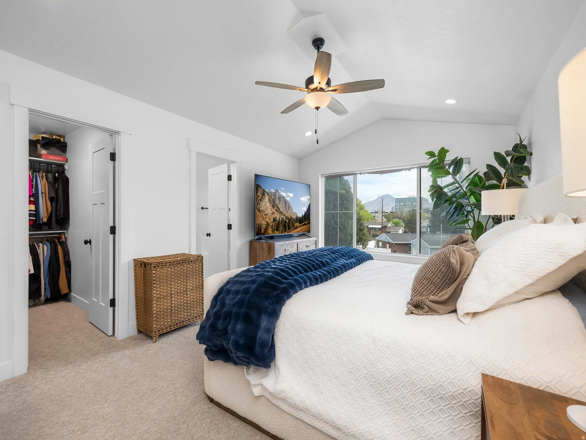 Bedroom featuring access to exterior, light colored carpet, a spacious closet, a ceiling fan, and recessed lighting