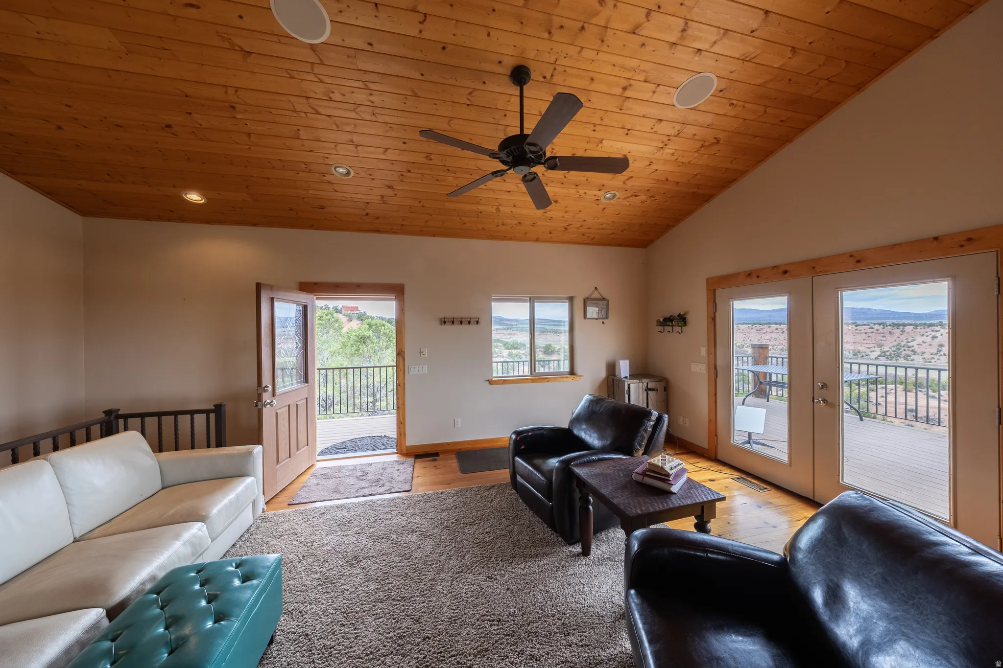 Living area with a vaulted wooden ceiling, a ceiling fan, light wood-style flooring, french doors, and recessed lighting