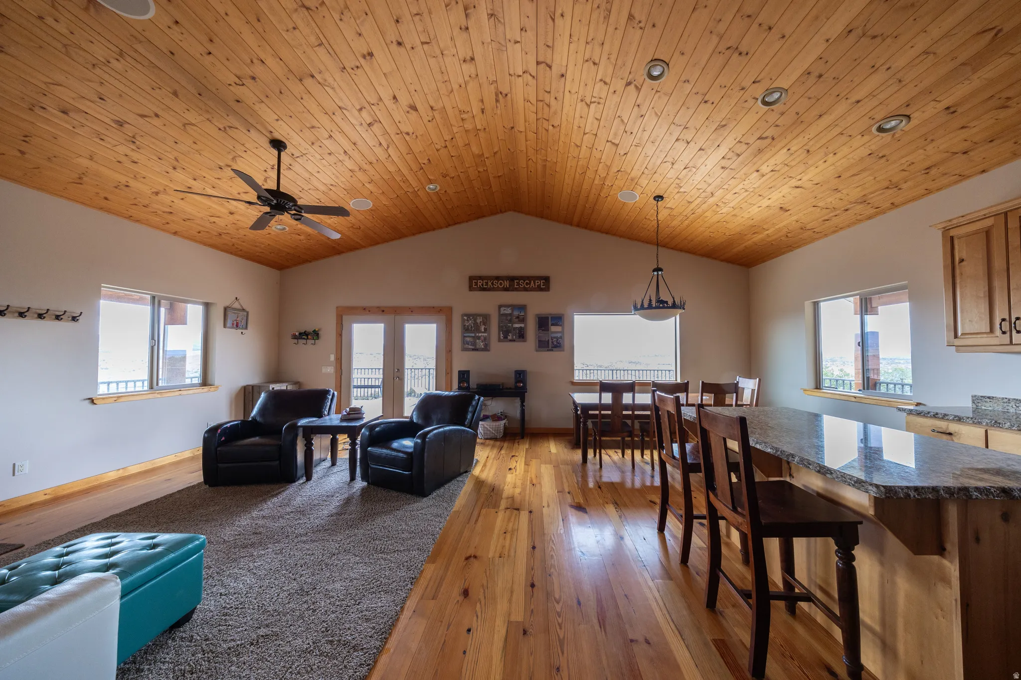Living area with light wood-type flooring, wooden ceiling, french doors, and a ceiling fan