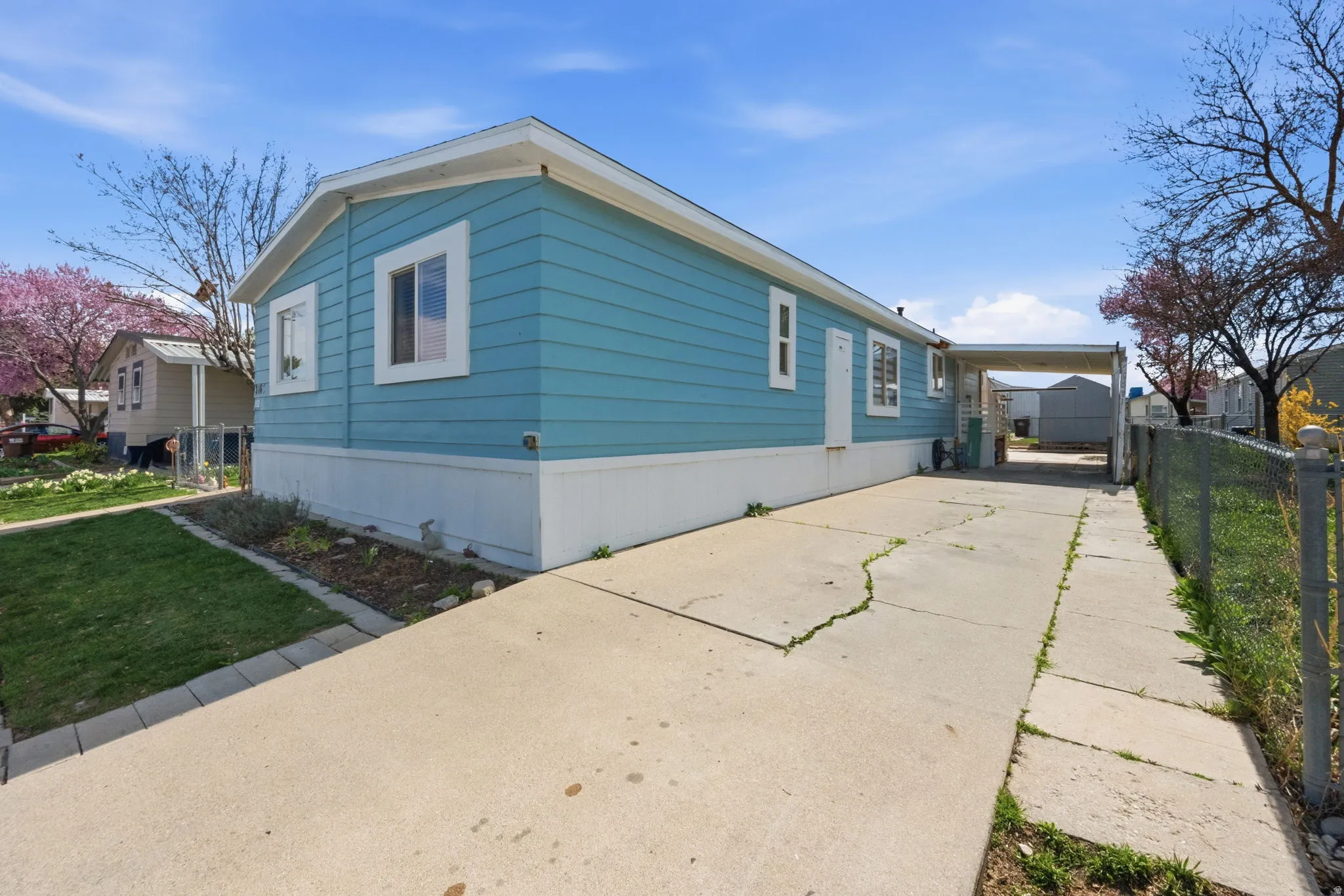 View of side of property featuring concrete driveway