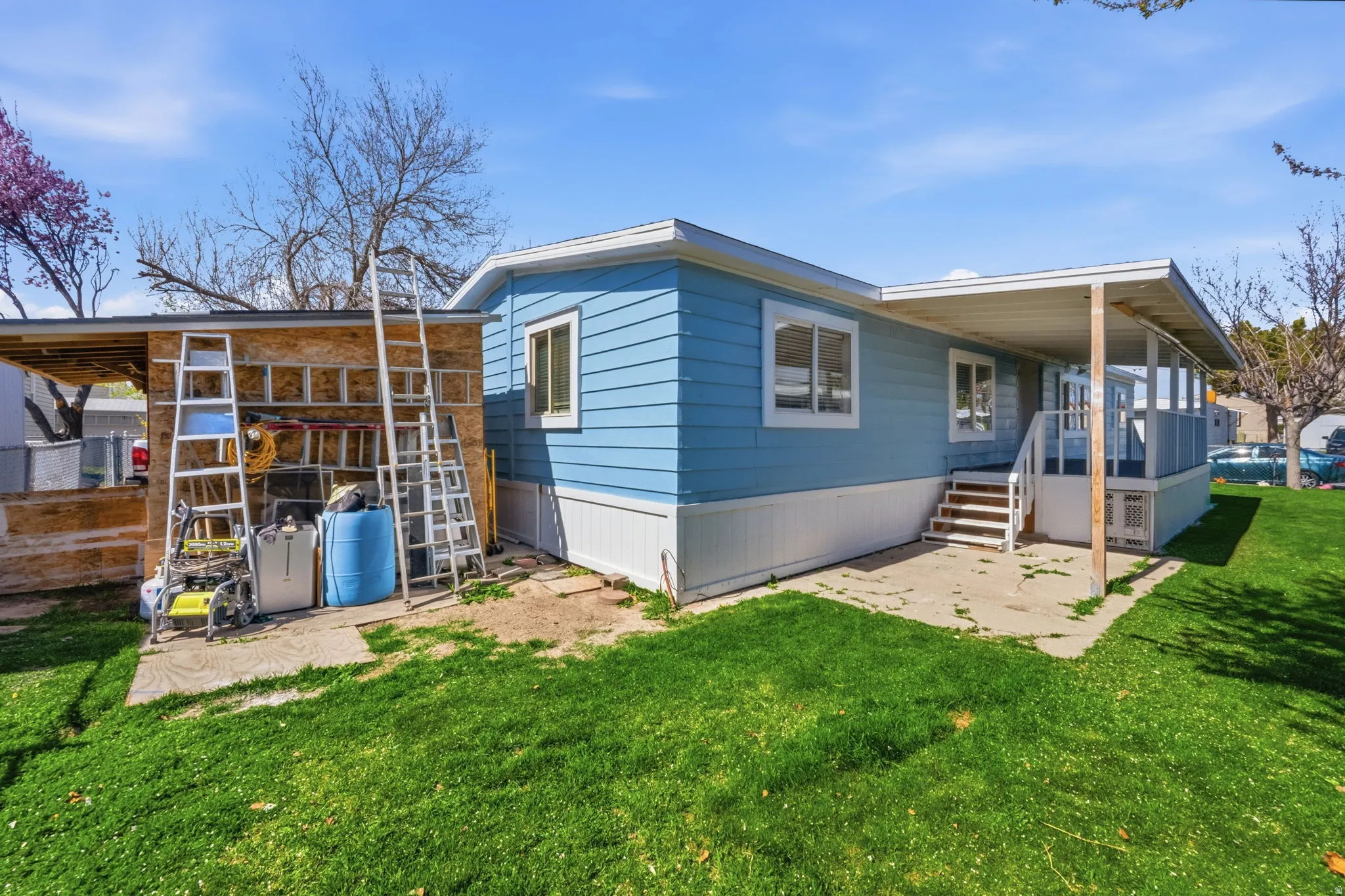 Rear view of house with a patio and a lawn