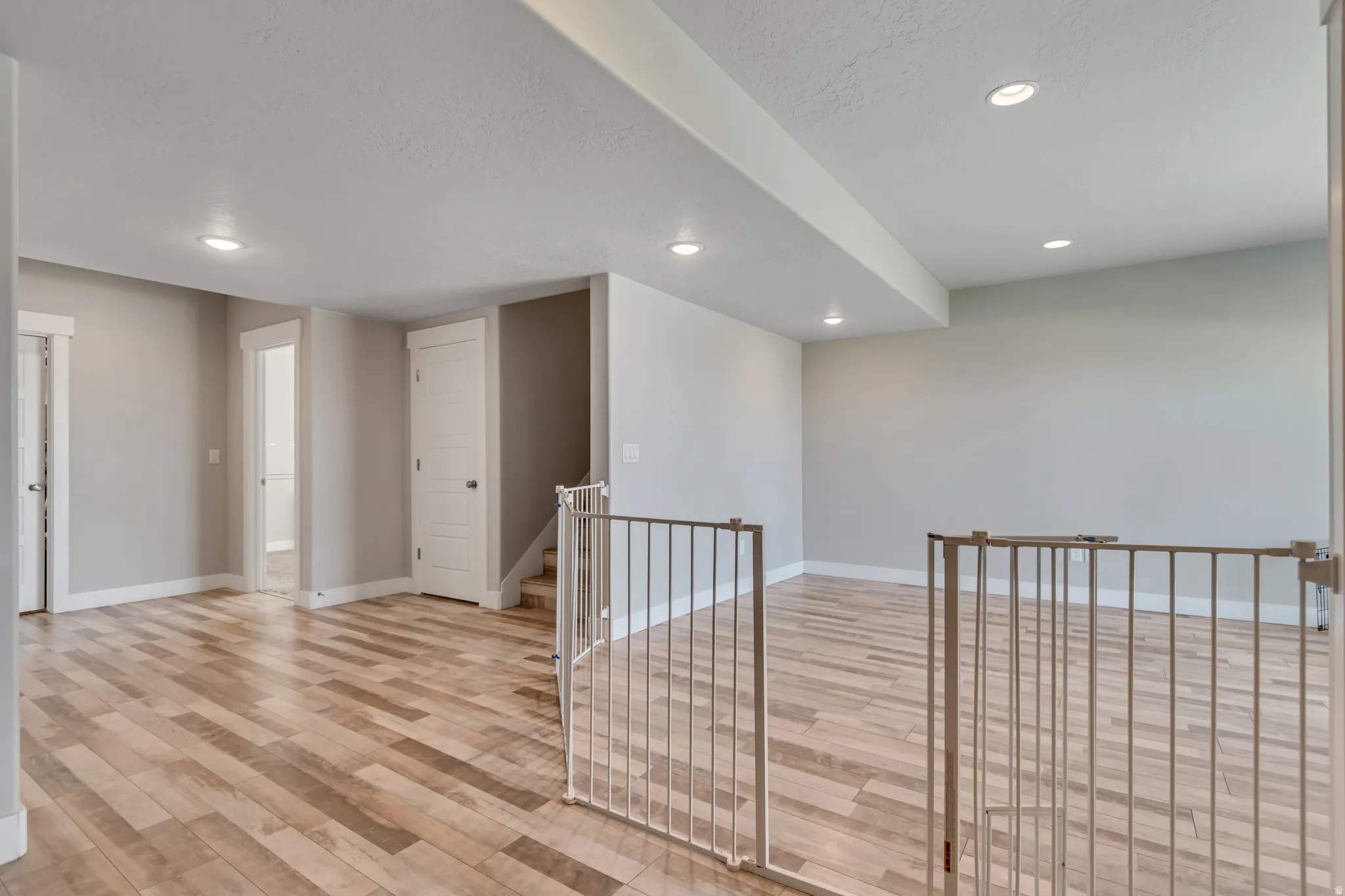 Spare room featuring light wood-type flooring, recessed lighting, and a textured ceiling