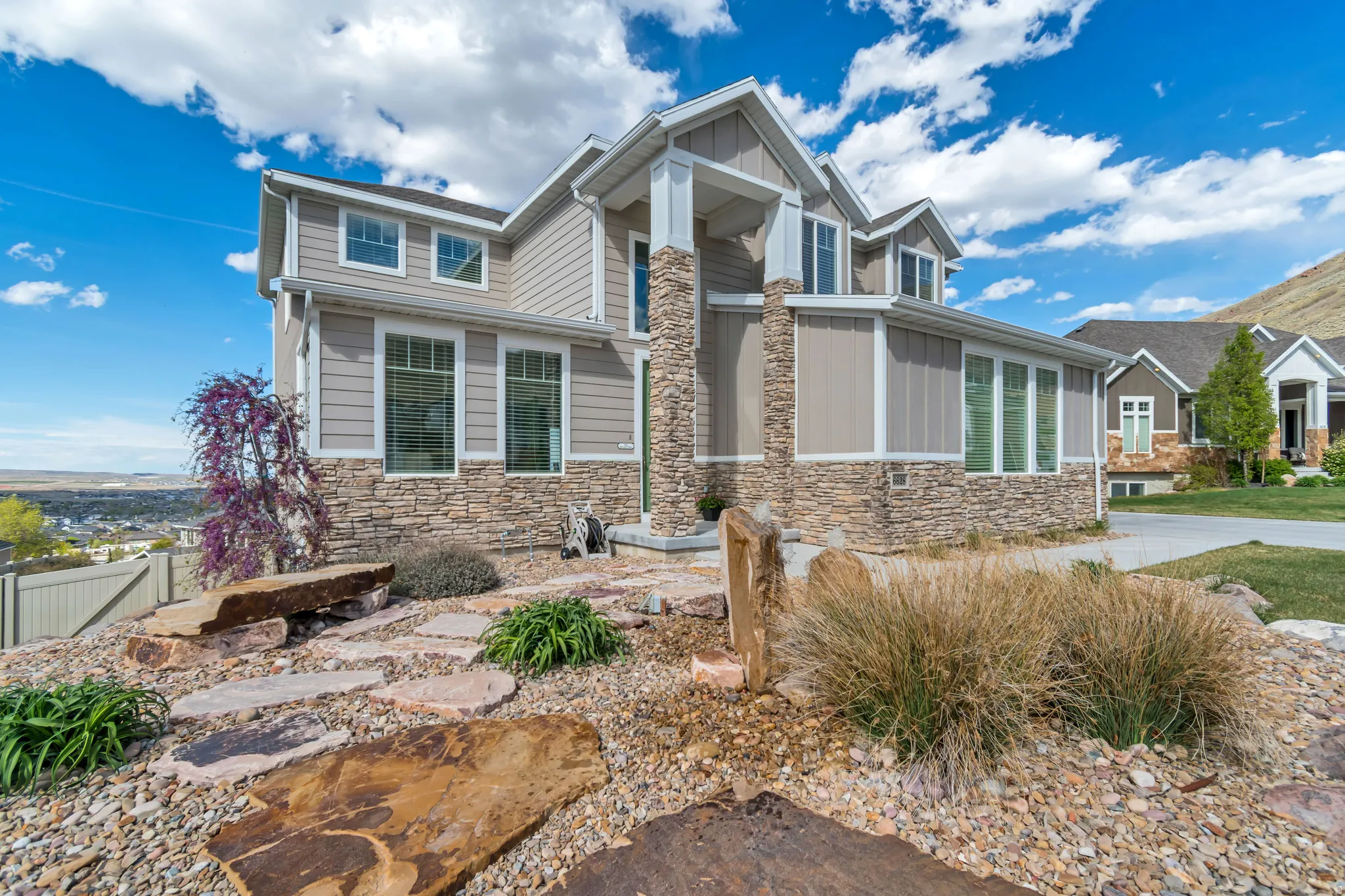 Craftsman-style house with stone siding and board and batten siding