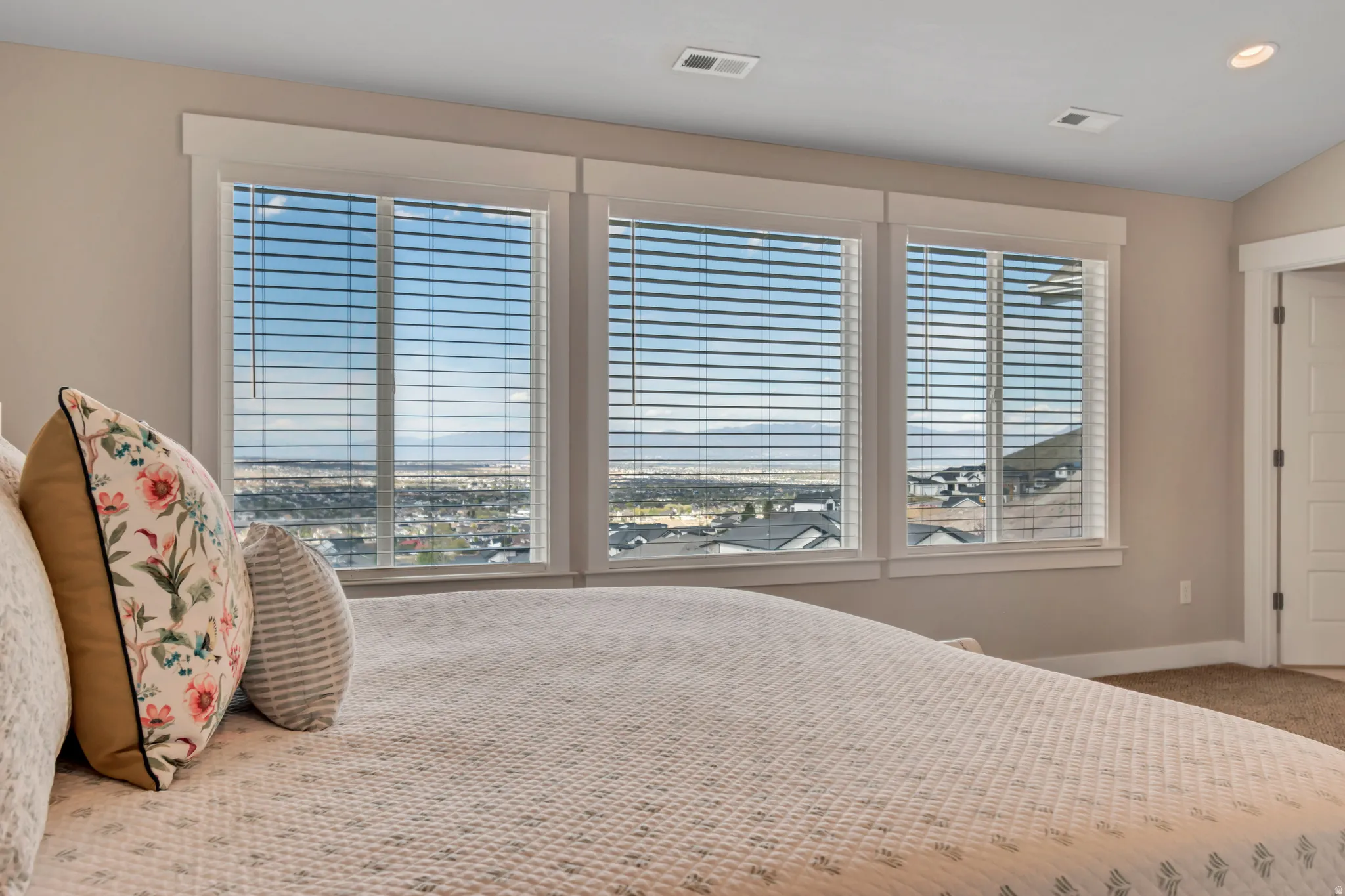 Carpeted bedroom with lofted ceiling and baseboards