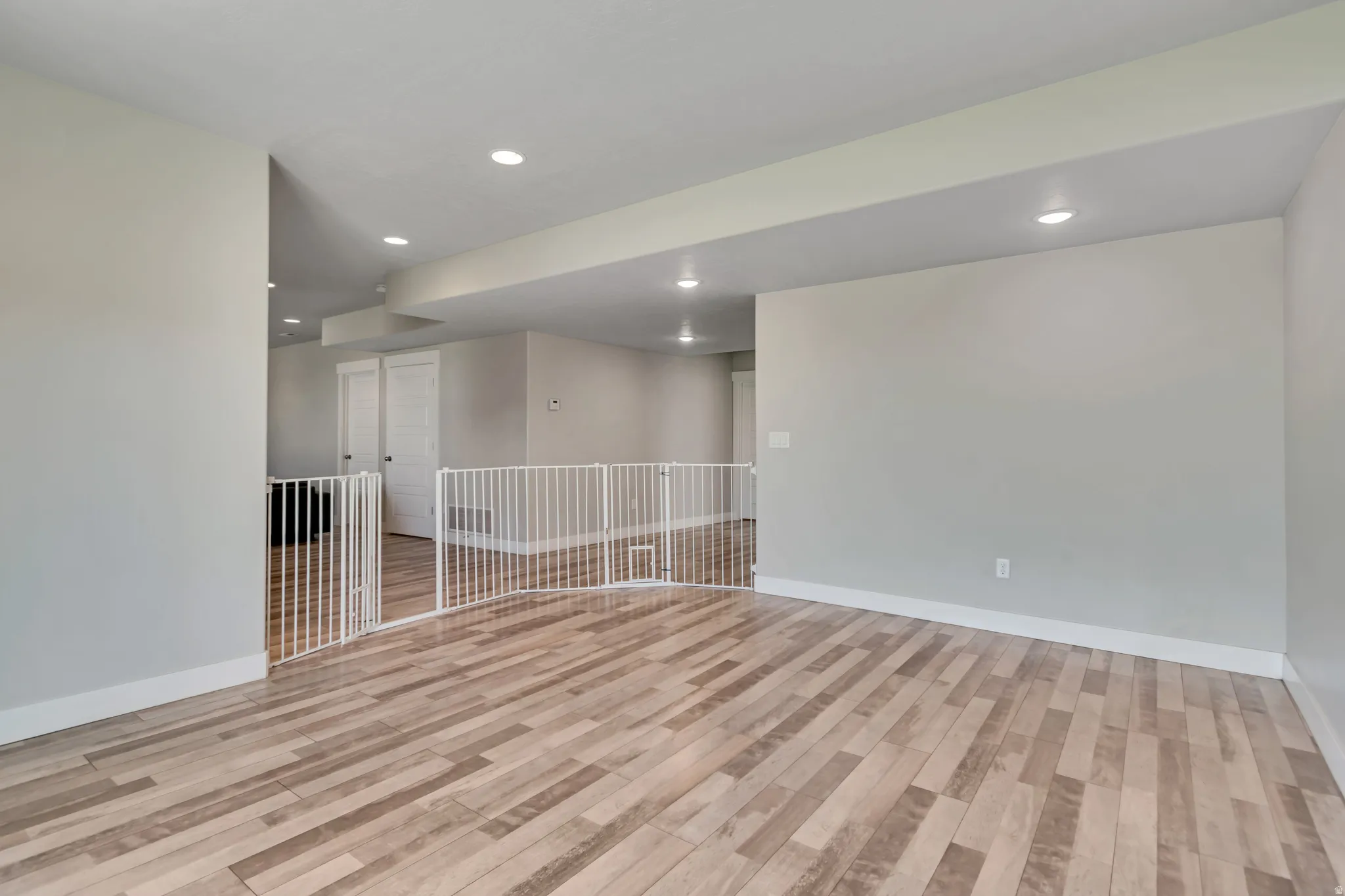 Spare room with light wood-style floors and recessed lighting