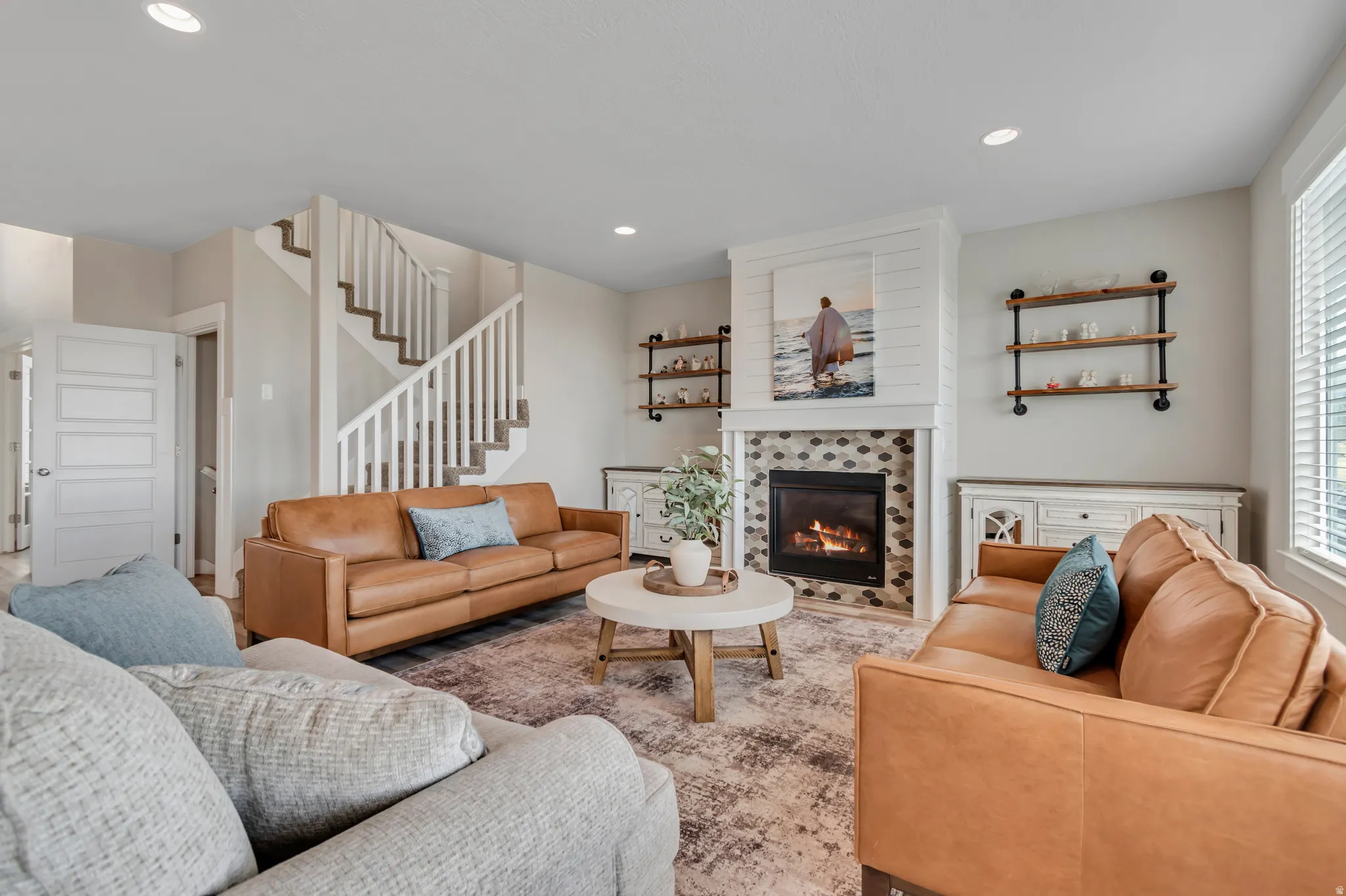 Living area with a tile fireplace and recessed lighting