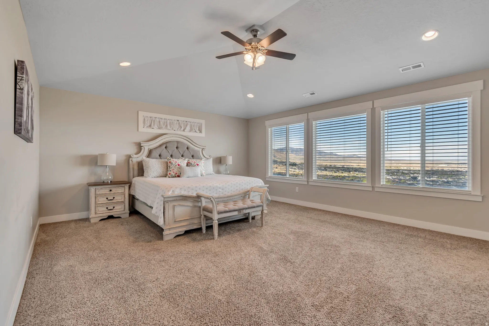 Bedroom with light carpet, ceiling fan, lofted ceiling, and recessed lighting