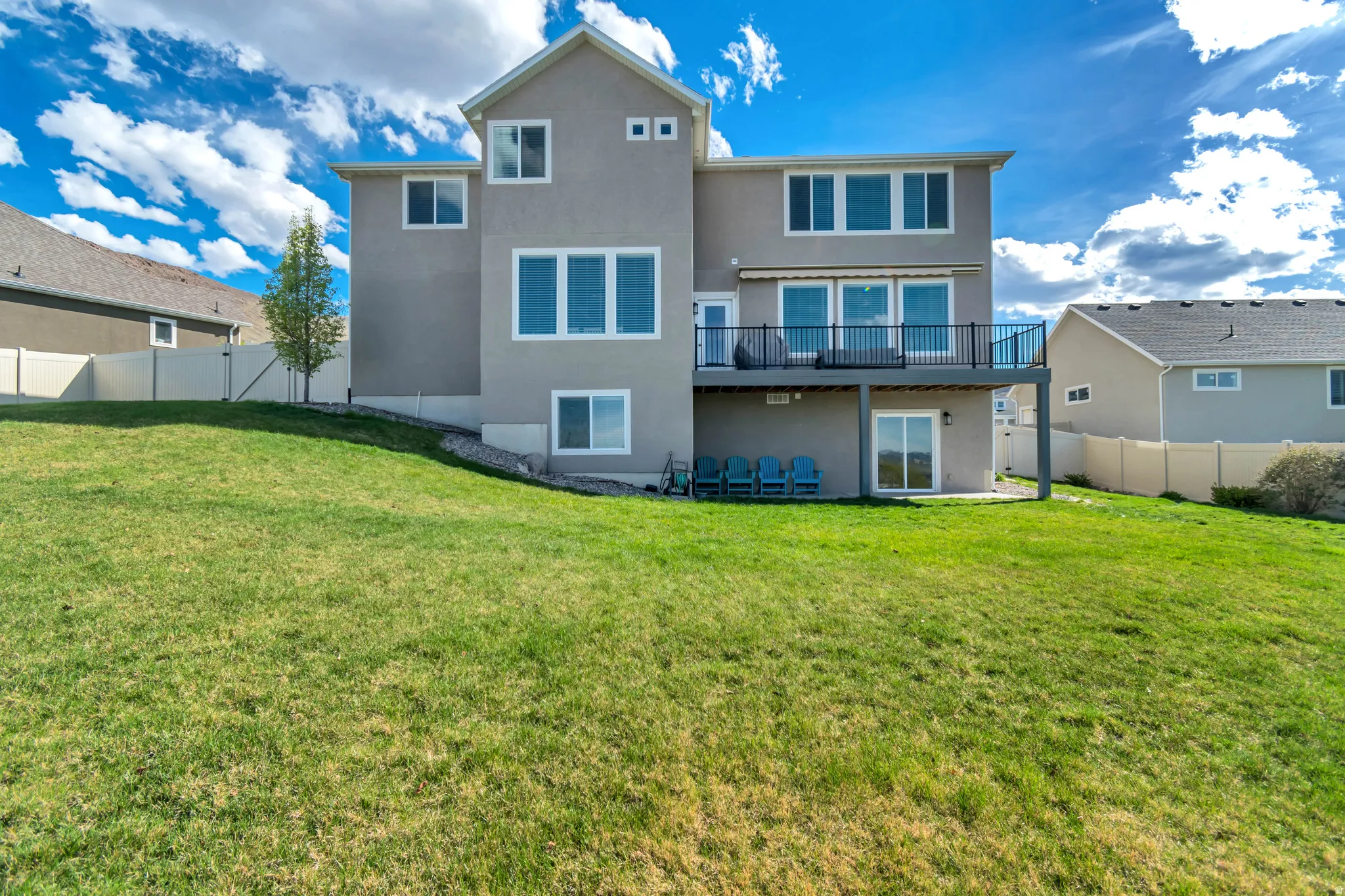 Rear view of property with a fenced backyard, stucco siding, and a patio