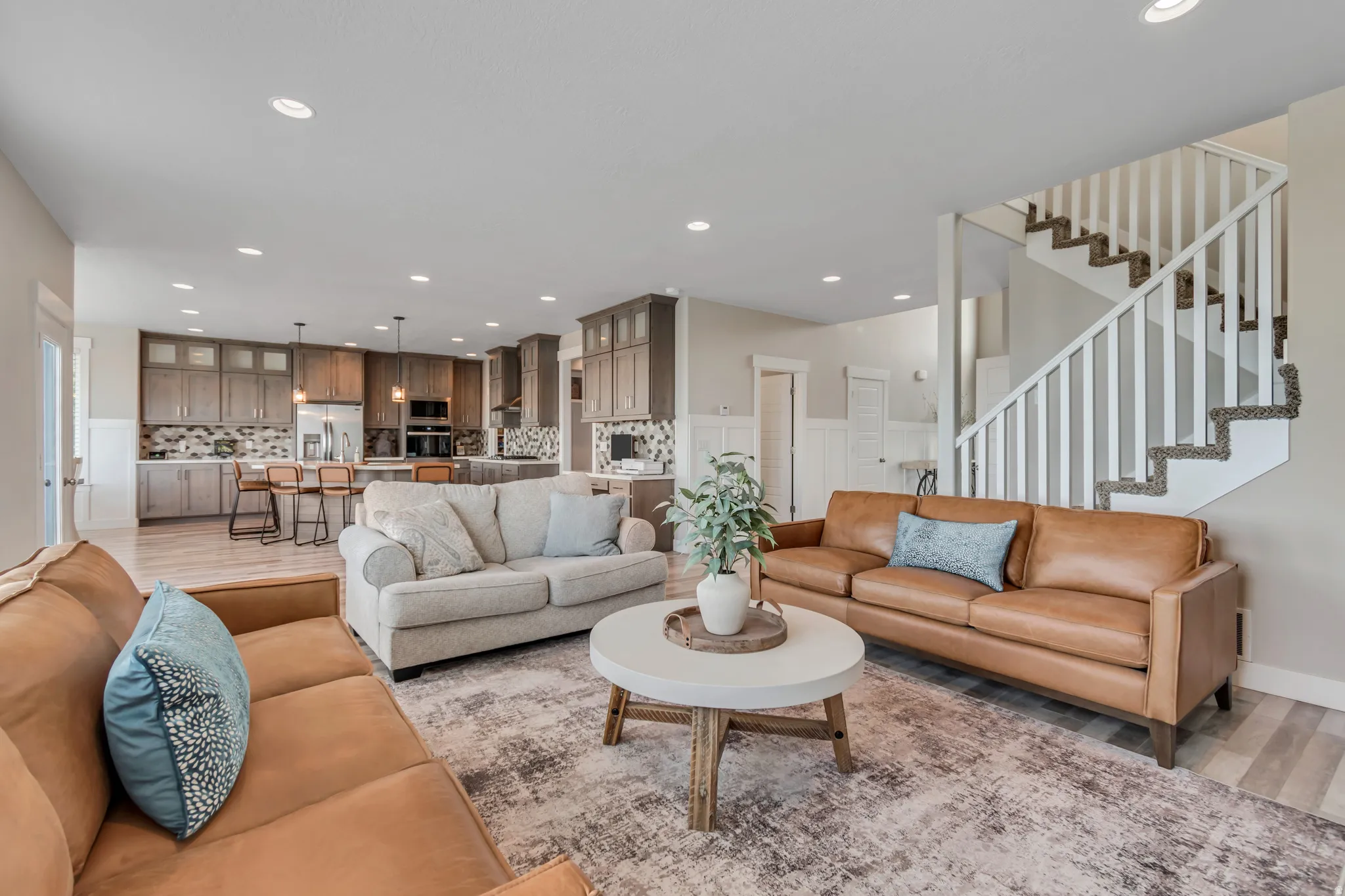 Living room with light wood-type flooring and recessed lighting