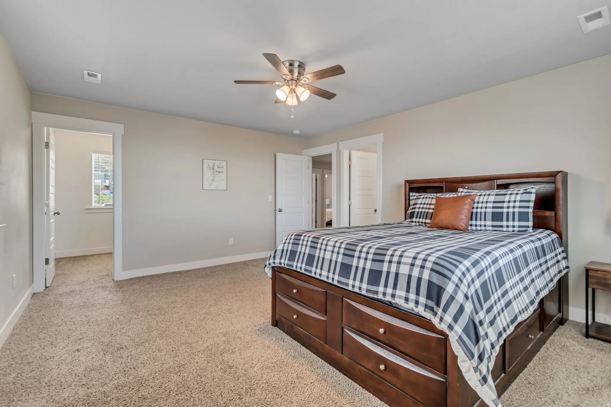 Bedroom featuring ceiling fan and light carpet