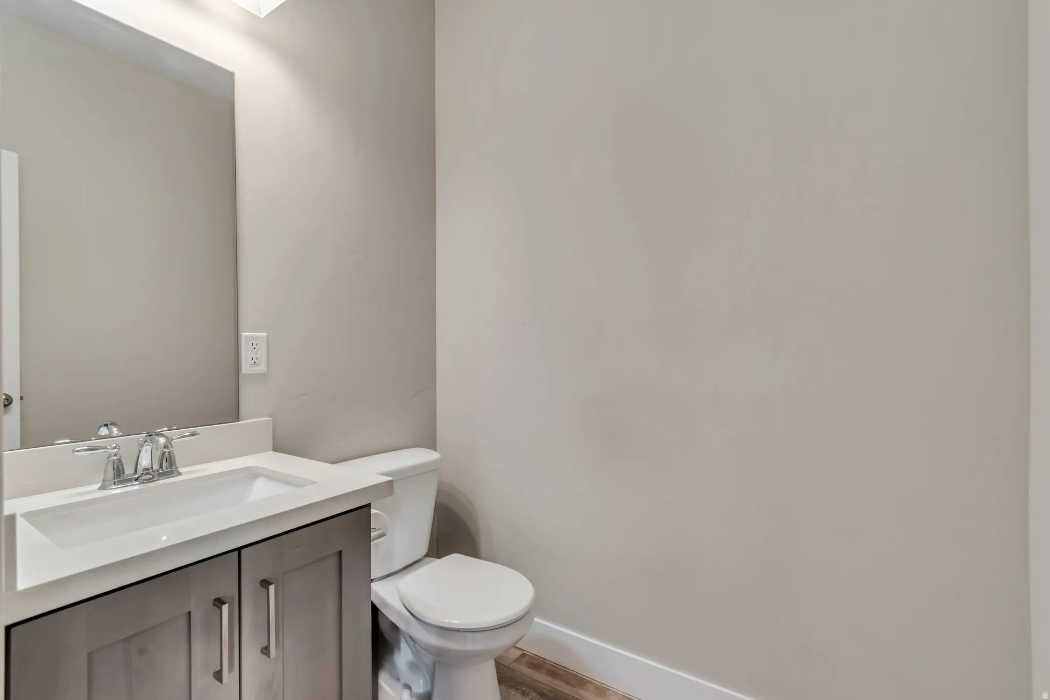Bathroom featuring vanity and light wood-style floors