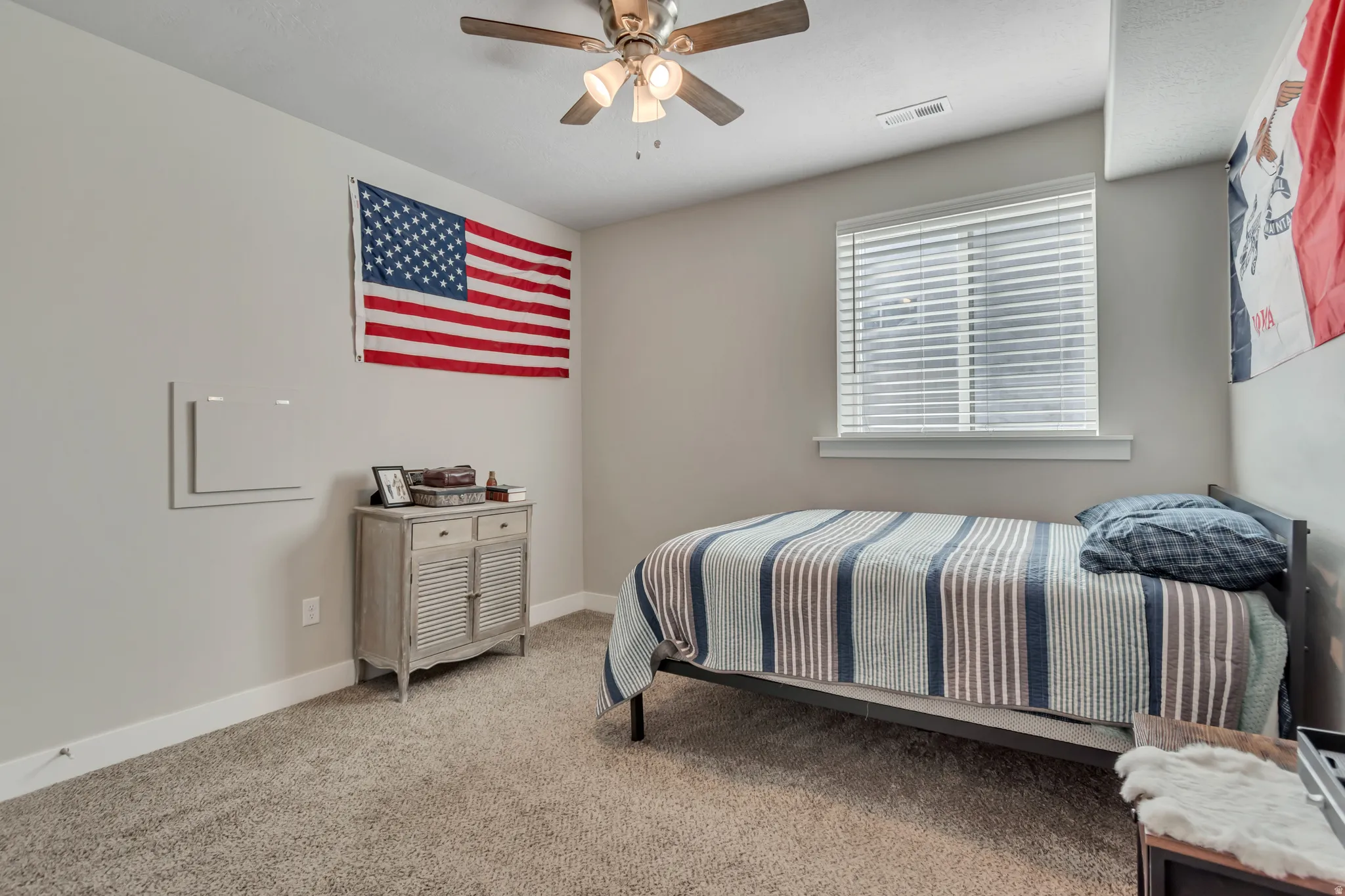Bedroom with light carpet and ceiling fan