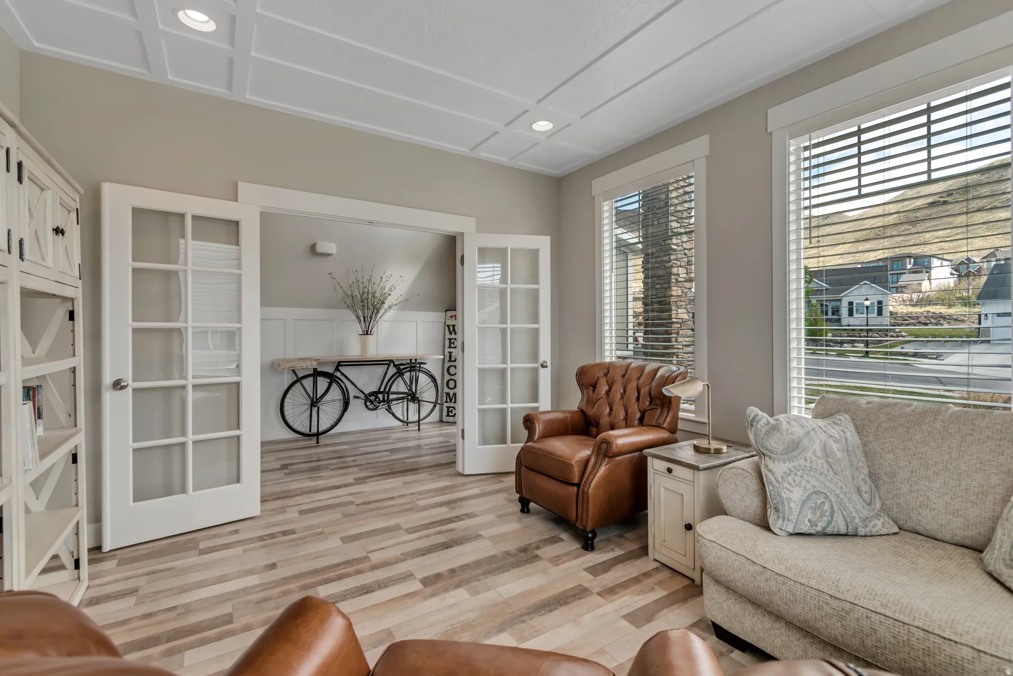 Living area with light wood-style flooring, recessed lighting, and french doors