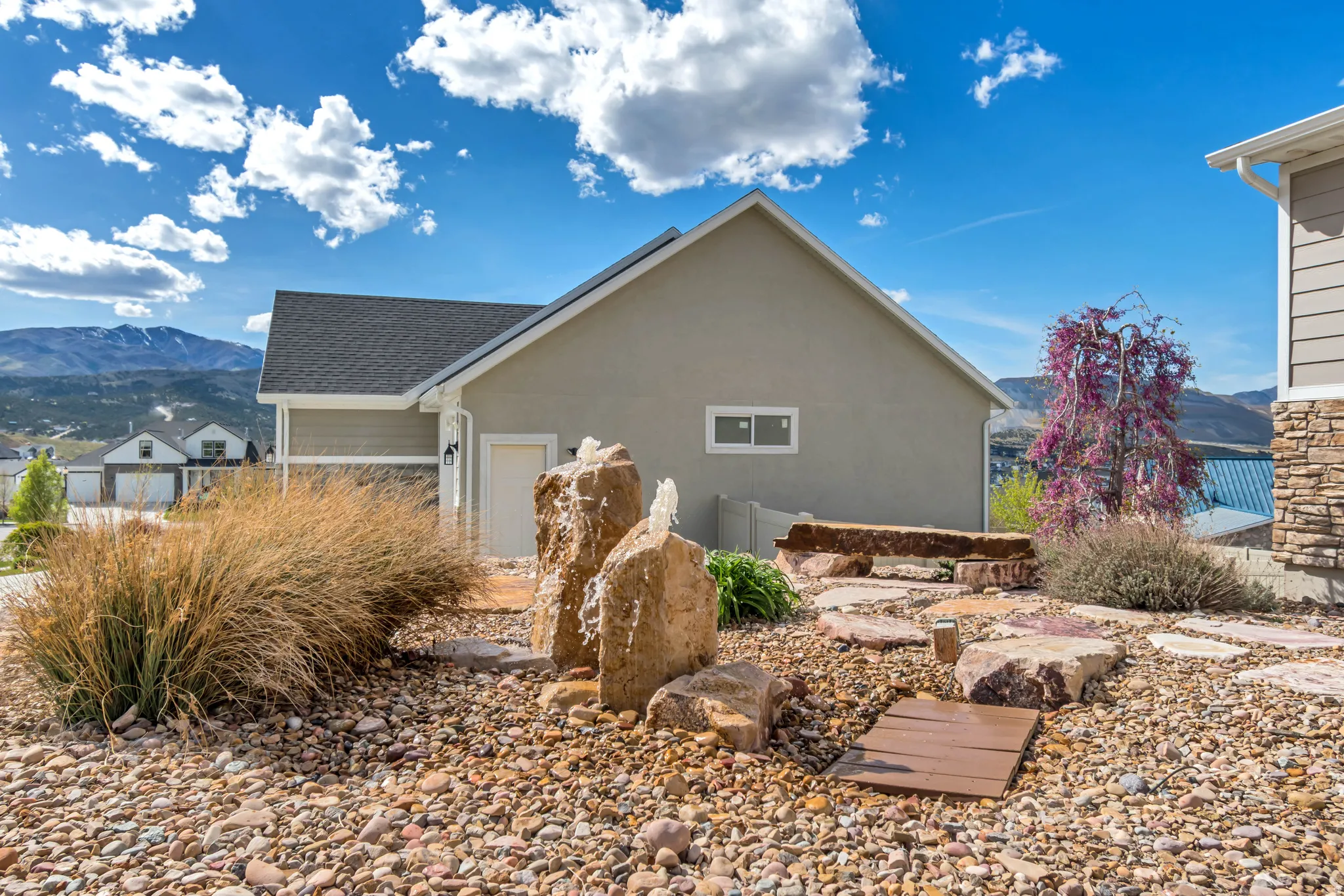 View of side of home featuring a mountain view and stucco siding
