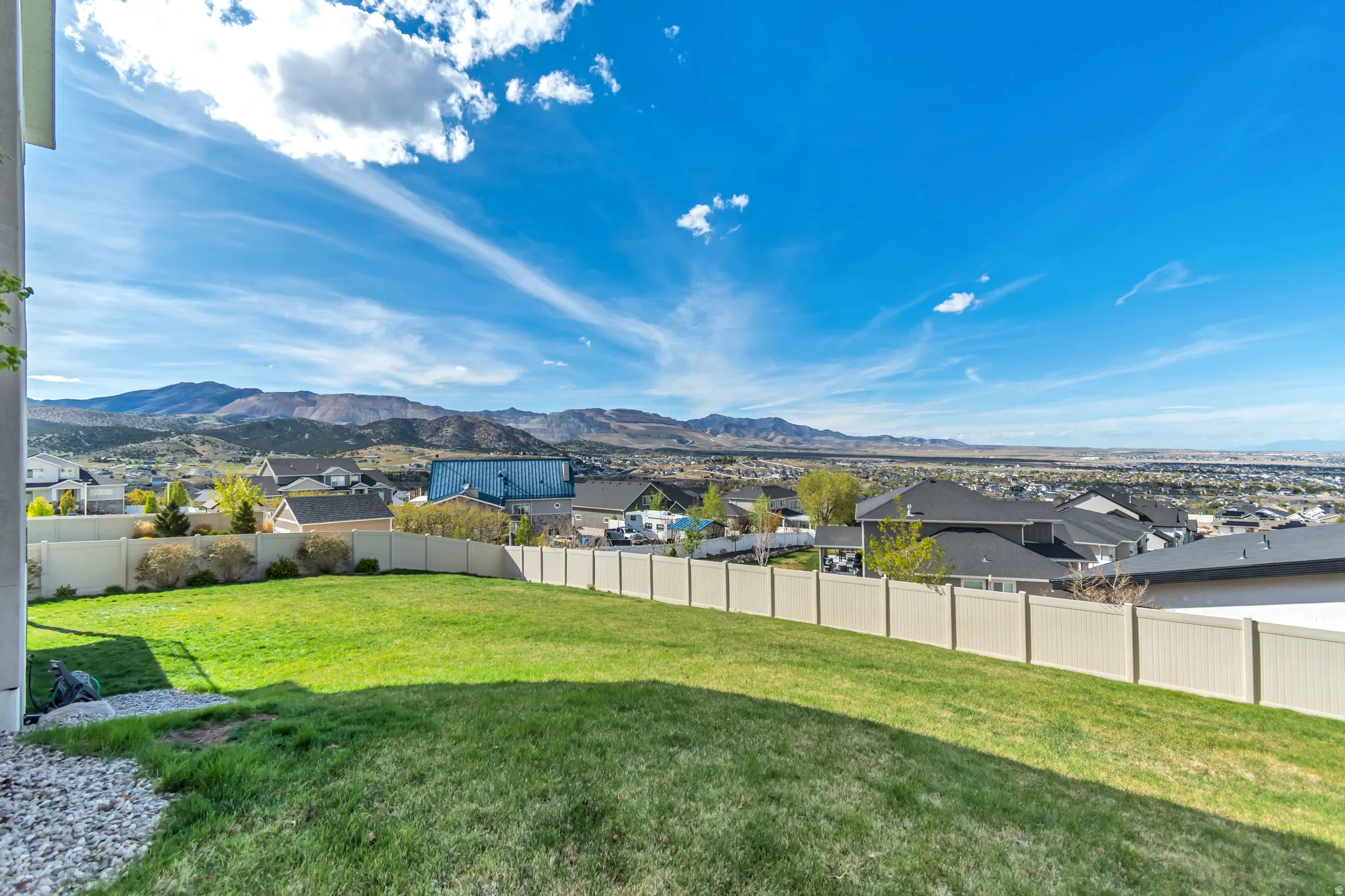 Fenced backyard with a residential view and a mountain view