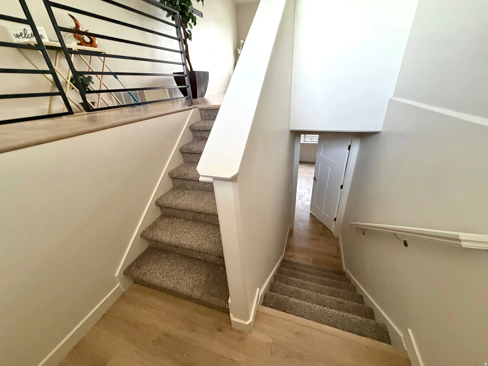 Staircase featuring wood finished floors and baseboards