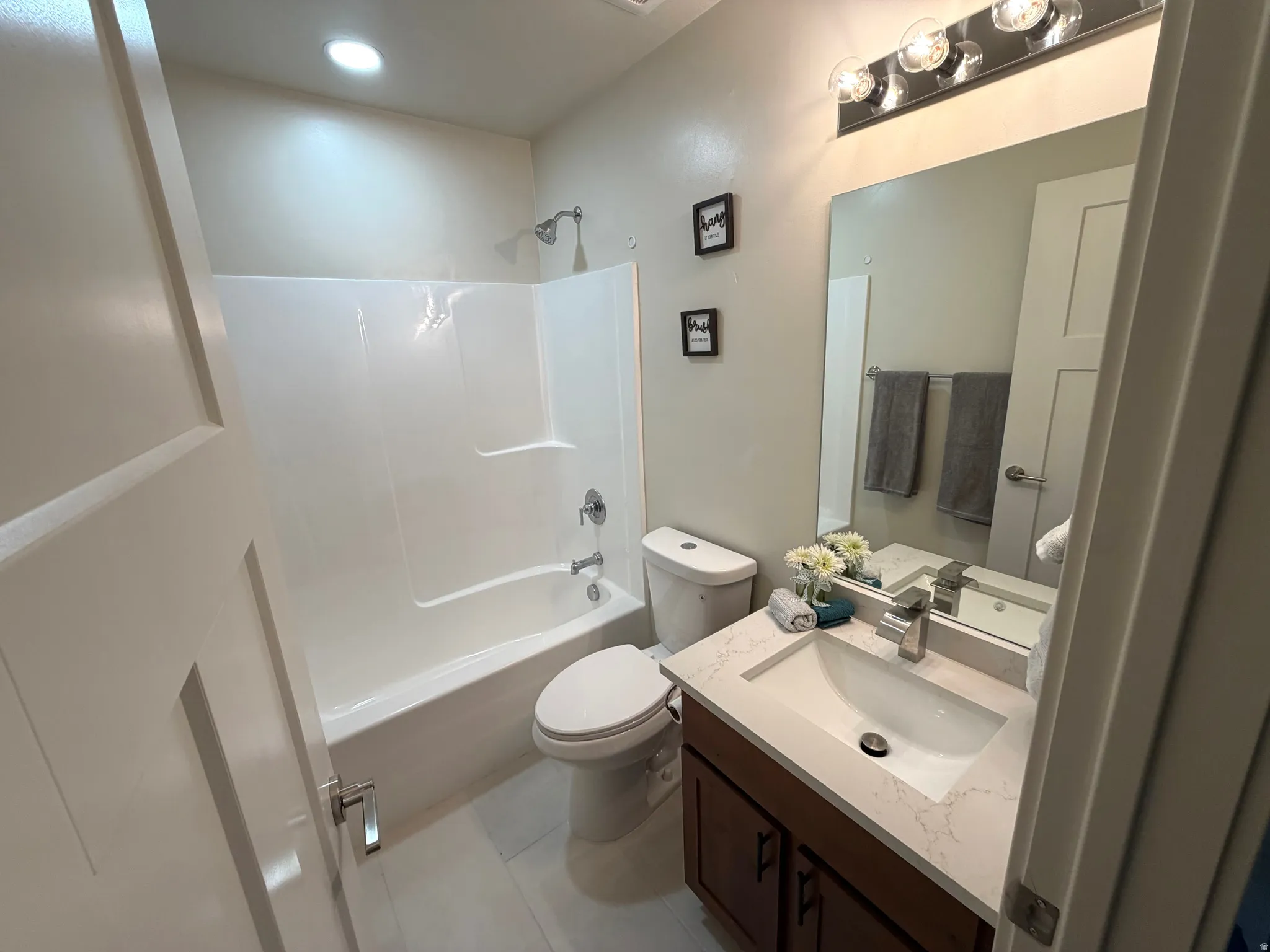 Full bathroom with vanity, shower / washtub combination, and light tile patterned flooring