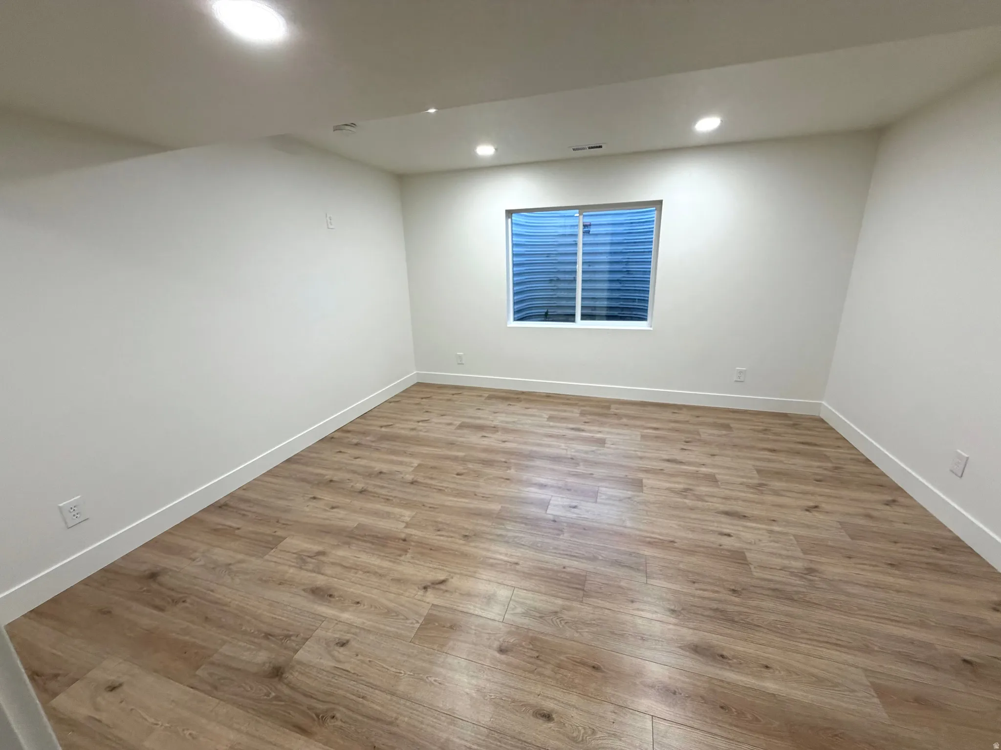 Spare room featuring light wood-type flooring and recessed lighting