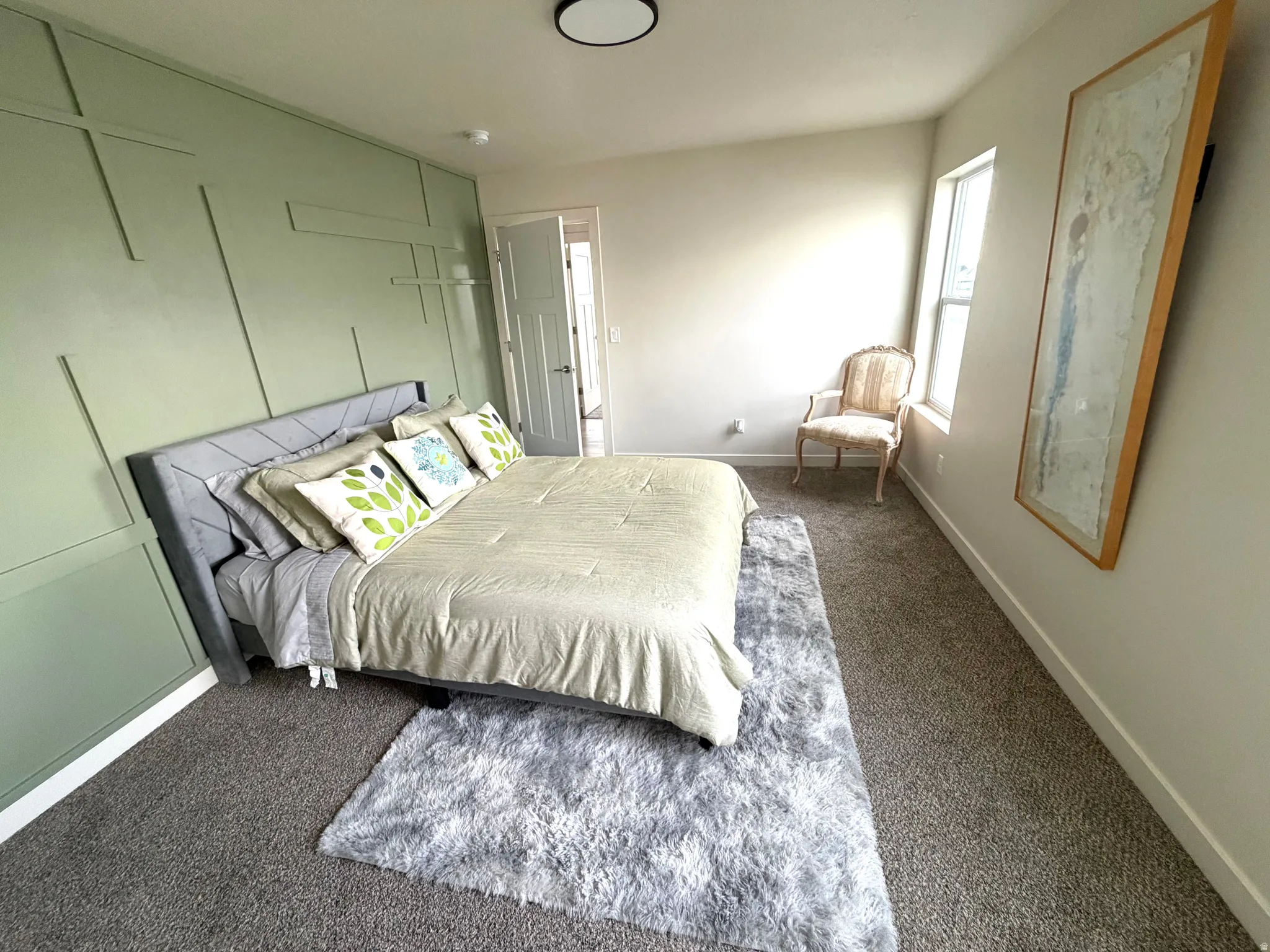 Bedroom with baseboards and dark carpet