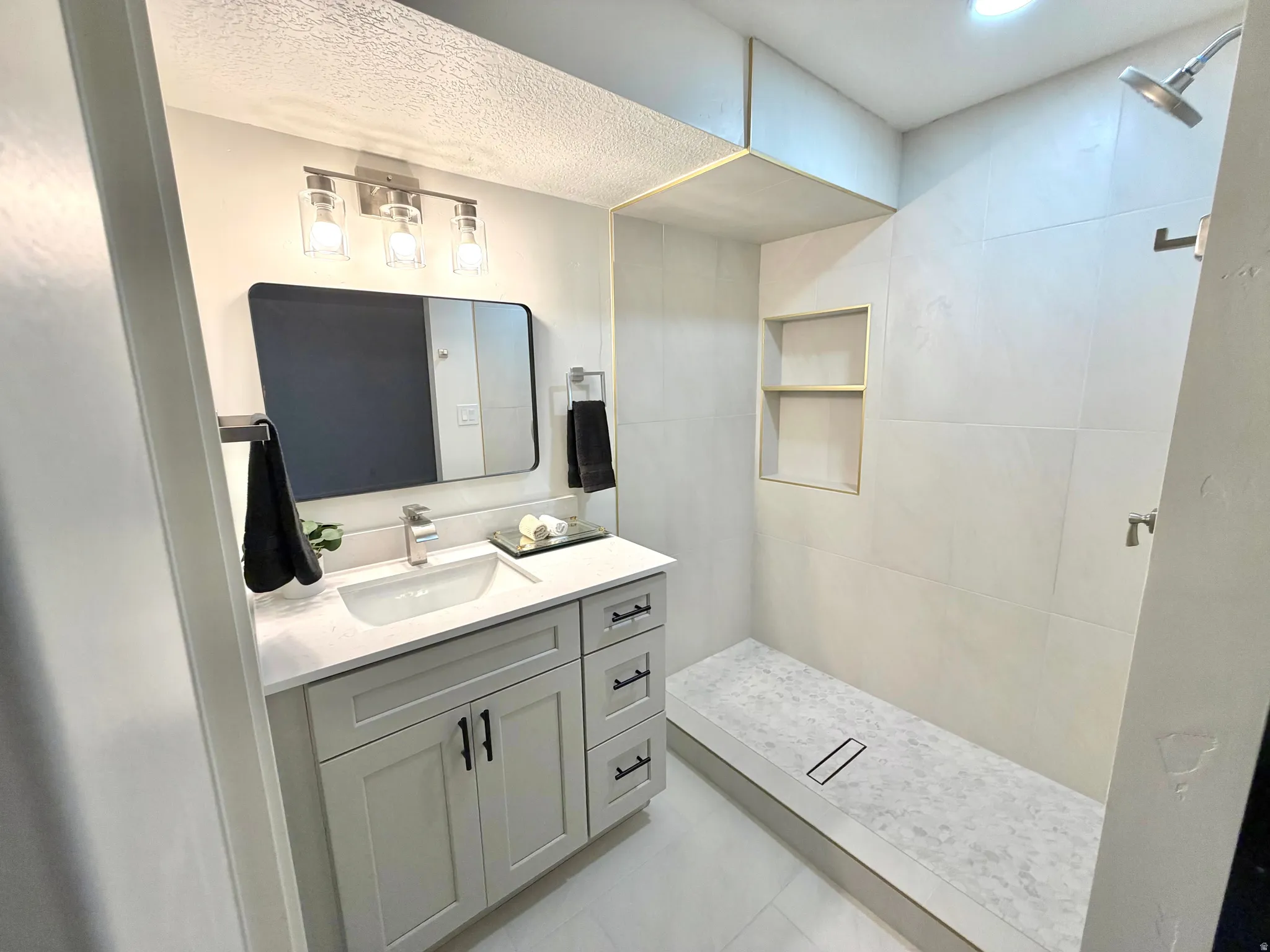 Bathroom with vanity and walk in shower