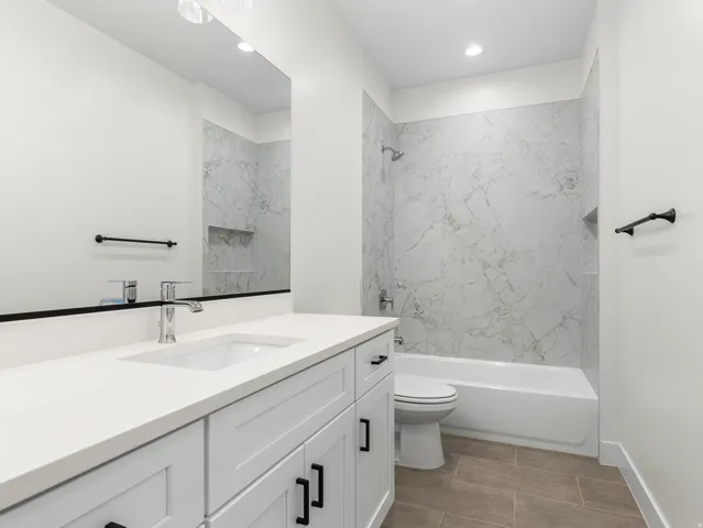 Full bath featuring vanity, bathing tub / shower combination, and recessed lighting