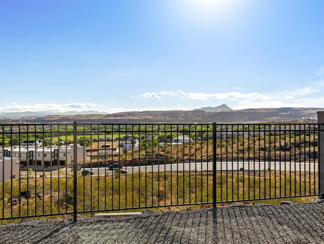 View of yard with a mountain view and a balcony