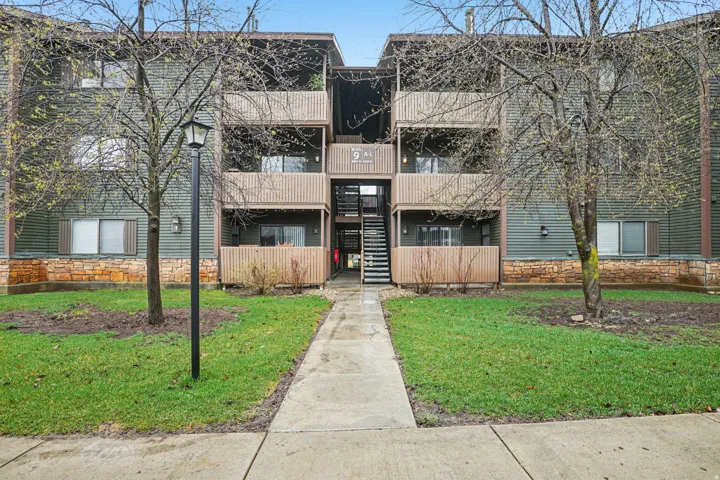 View of apartment building / complex featuring stairs