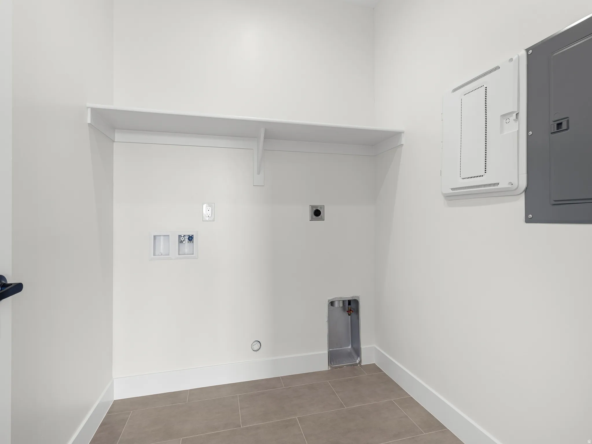 Laundry area featuring hookup for a washing machine, electric panel, and hookup for an electric dryer