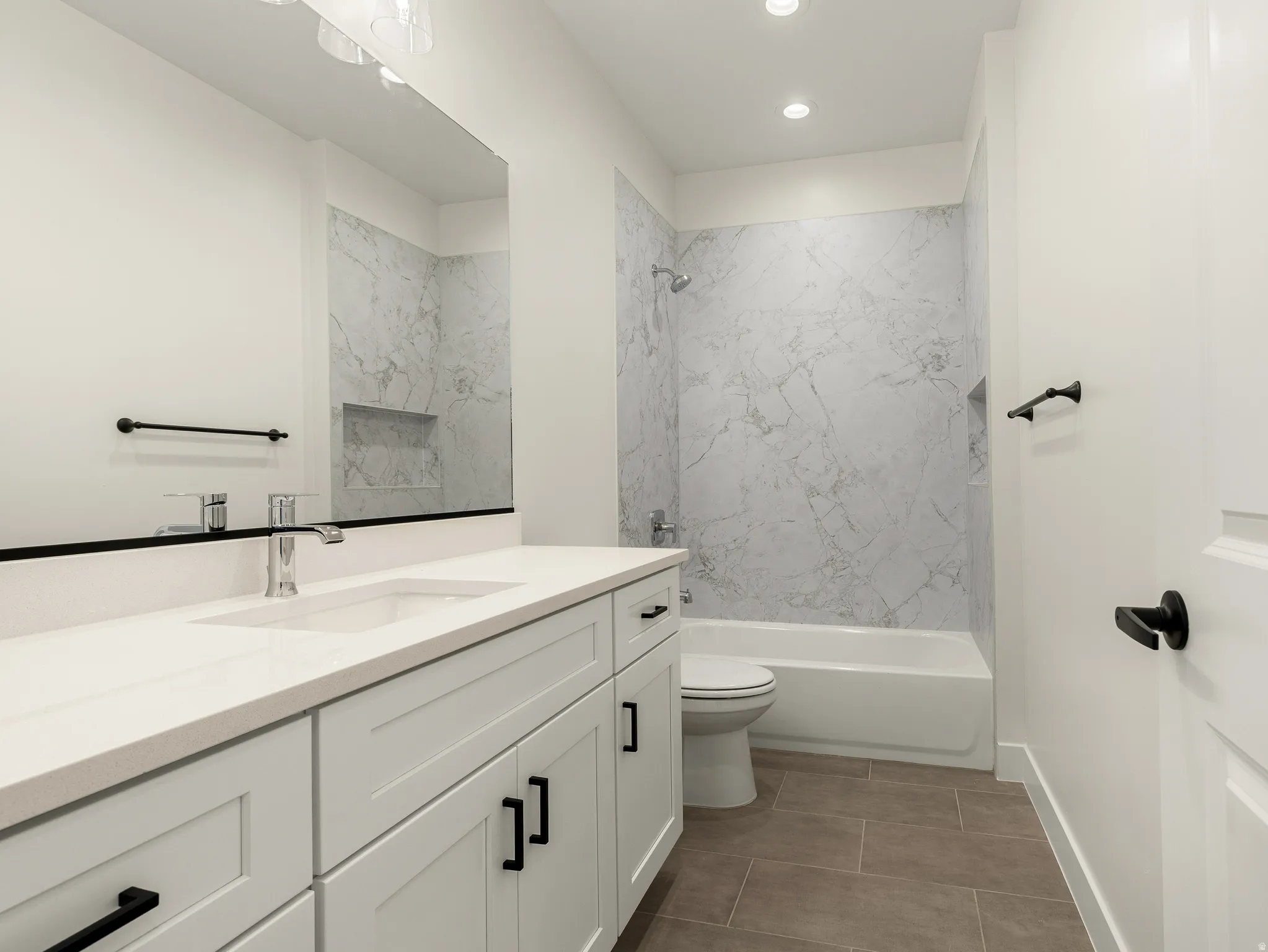 Bathroom with vanity and bathtub / shower combination