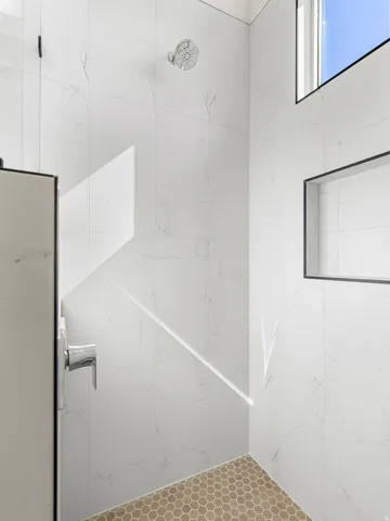 Full bath featuring a marble finish shower