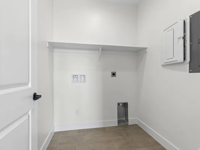 Laundry area with hookup for an electric dryer, electric panel, and hookup for a washing machine