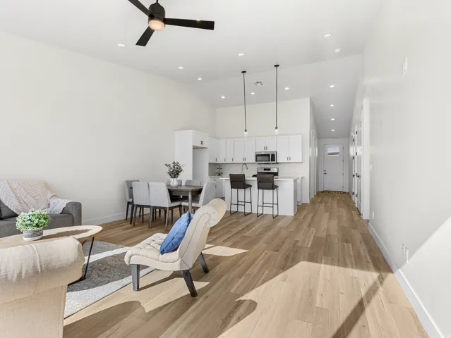 Living room featuring light wood finished floors, a ceiling fan, recessed lighting, and vaulted ceiling
