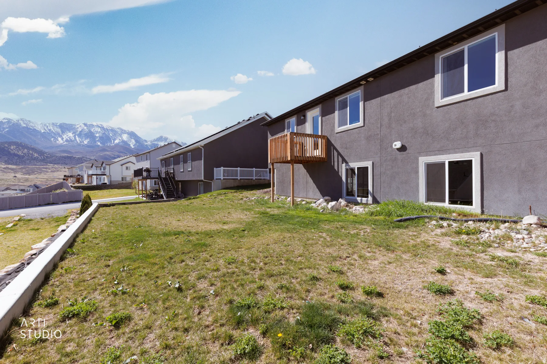 View of yard with a residential view and a deck with mountain view