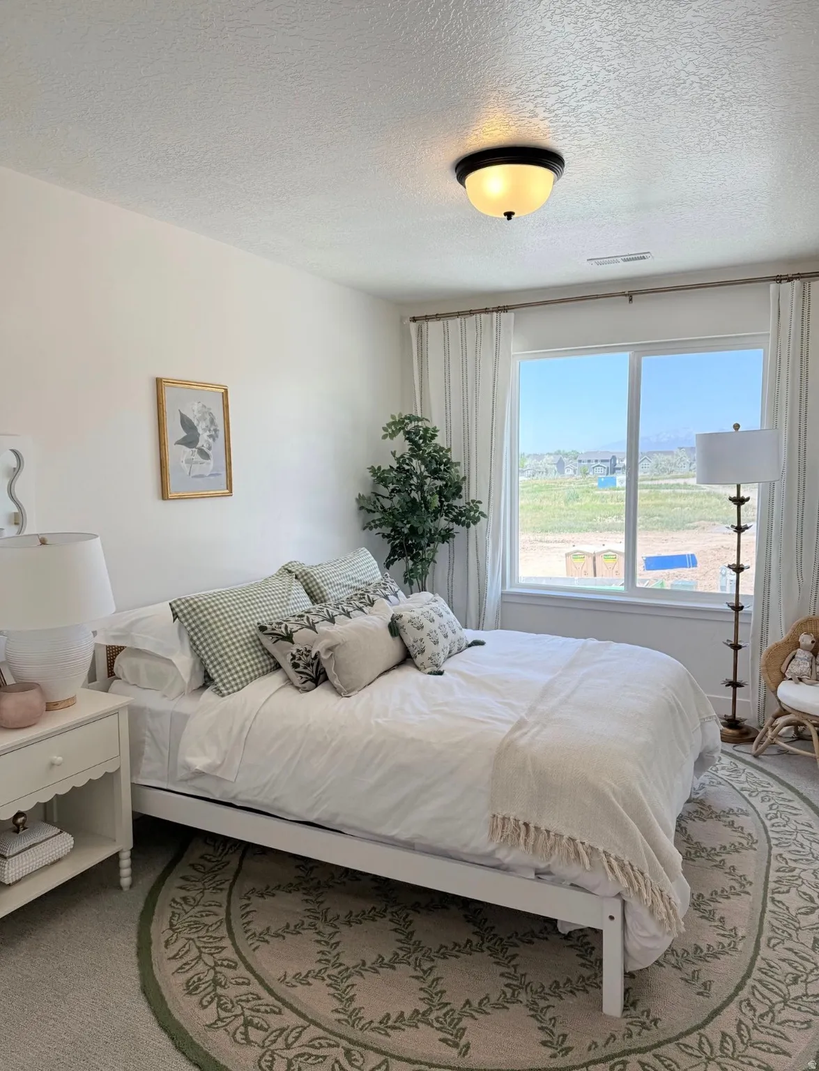 Spacious room featuring a large window, a ceiling-mounted light fixture, and light-colored walls