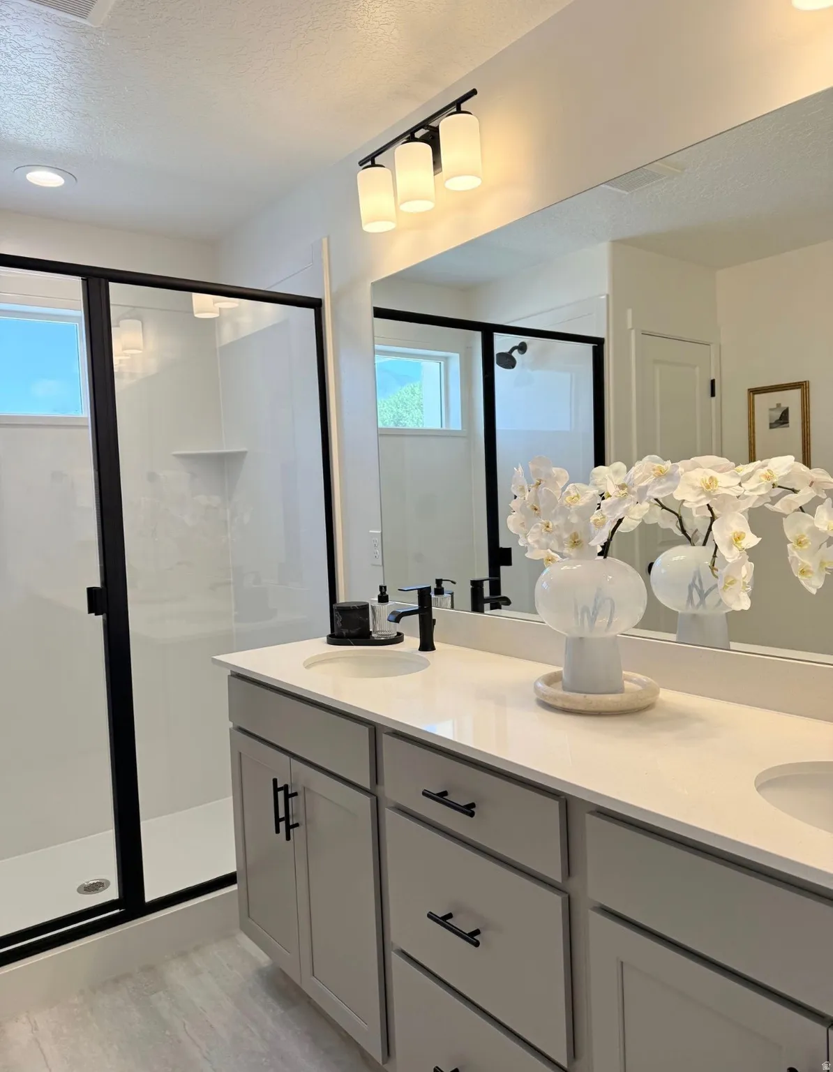 Dual vanity with white countertops and undermount sinks